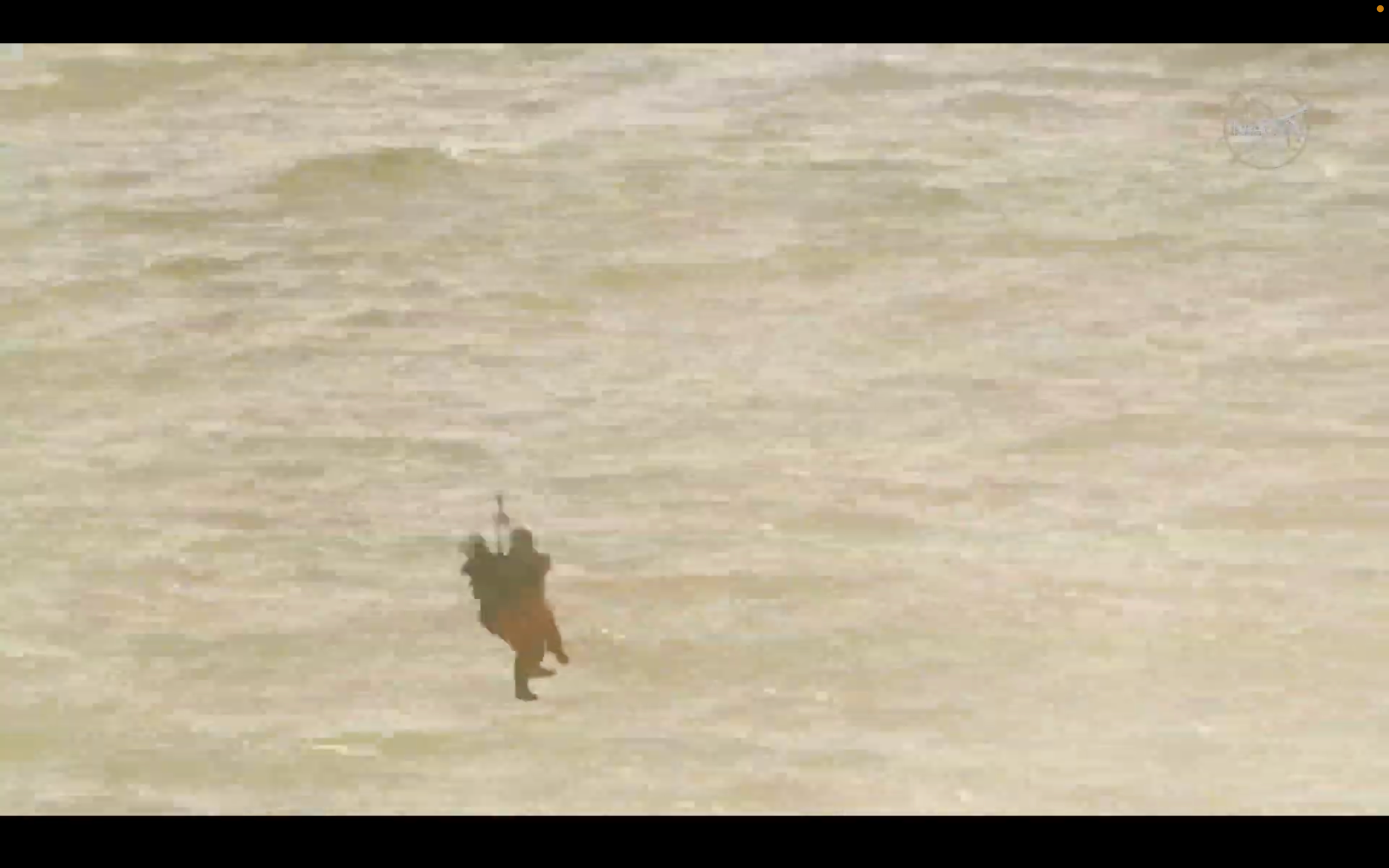 One of the Artemis II astronauts is hoisted beneath a helicopter to a U.S. Navy recovery ship