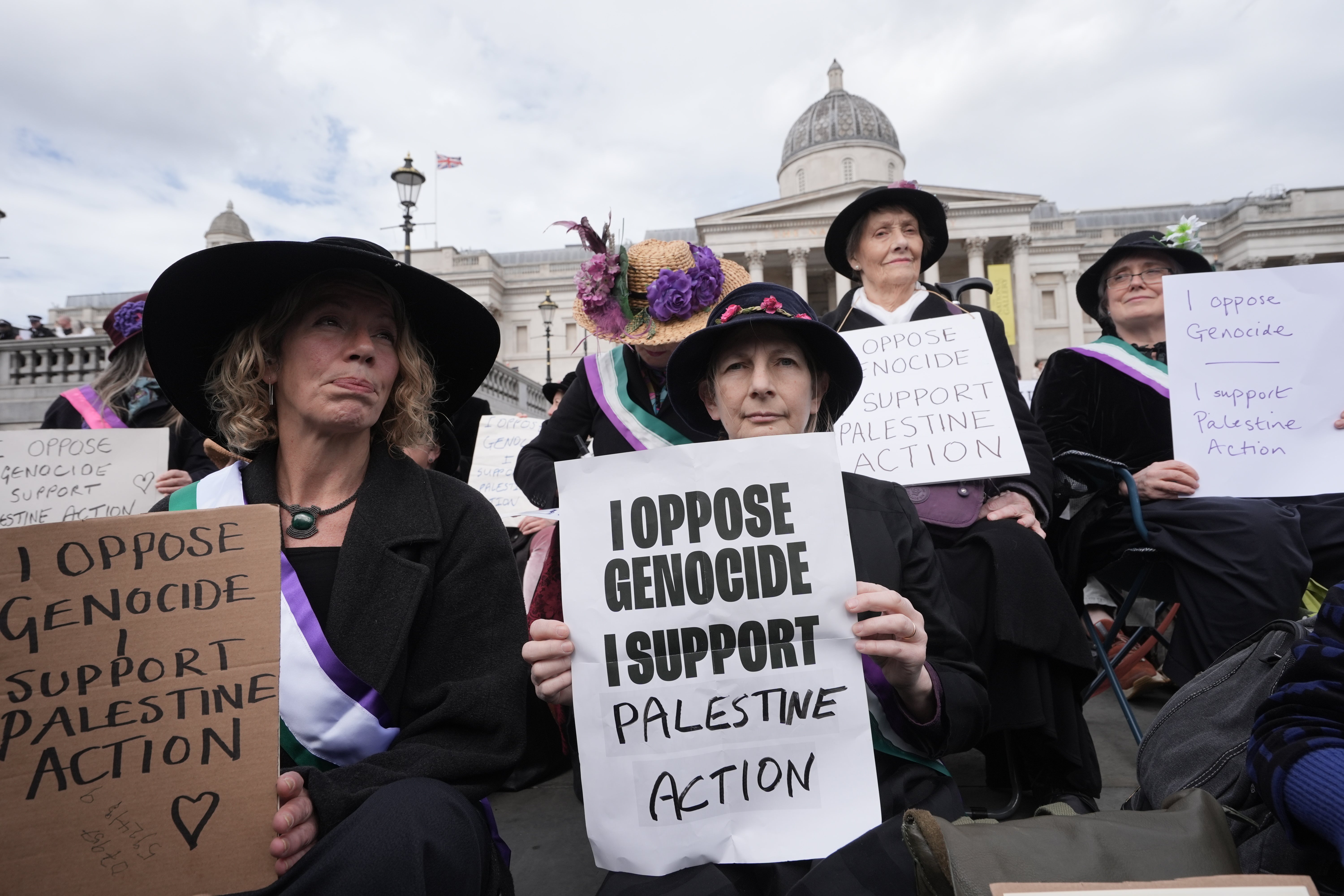 Protesters hold up placards at a demonstration against the ban on Palestine Action in Trafalgar Square, central London
