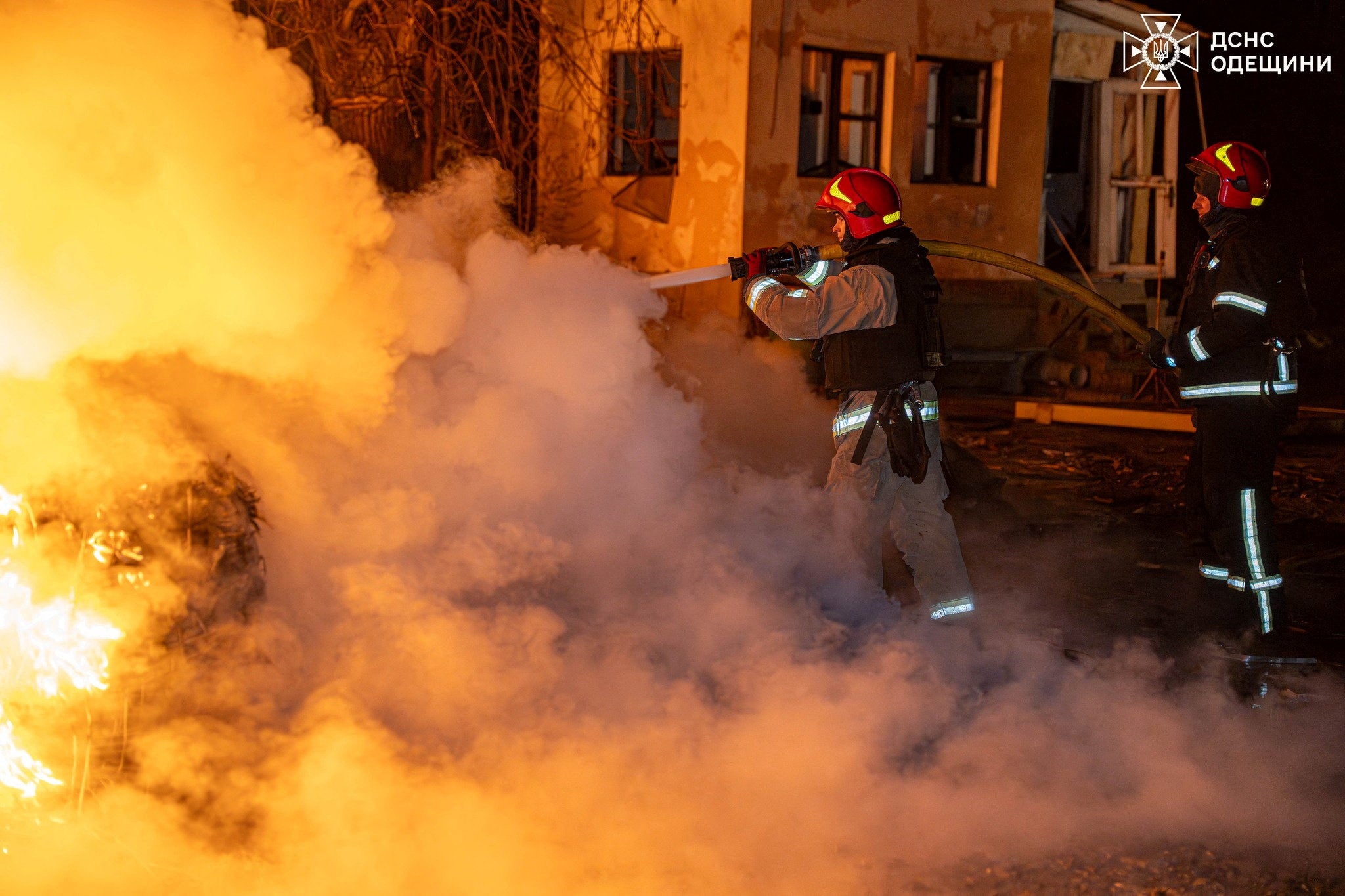 Firefighters work at the site of an overnight Russian drone strike in Odesa