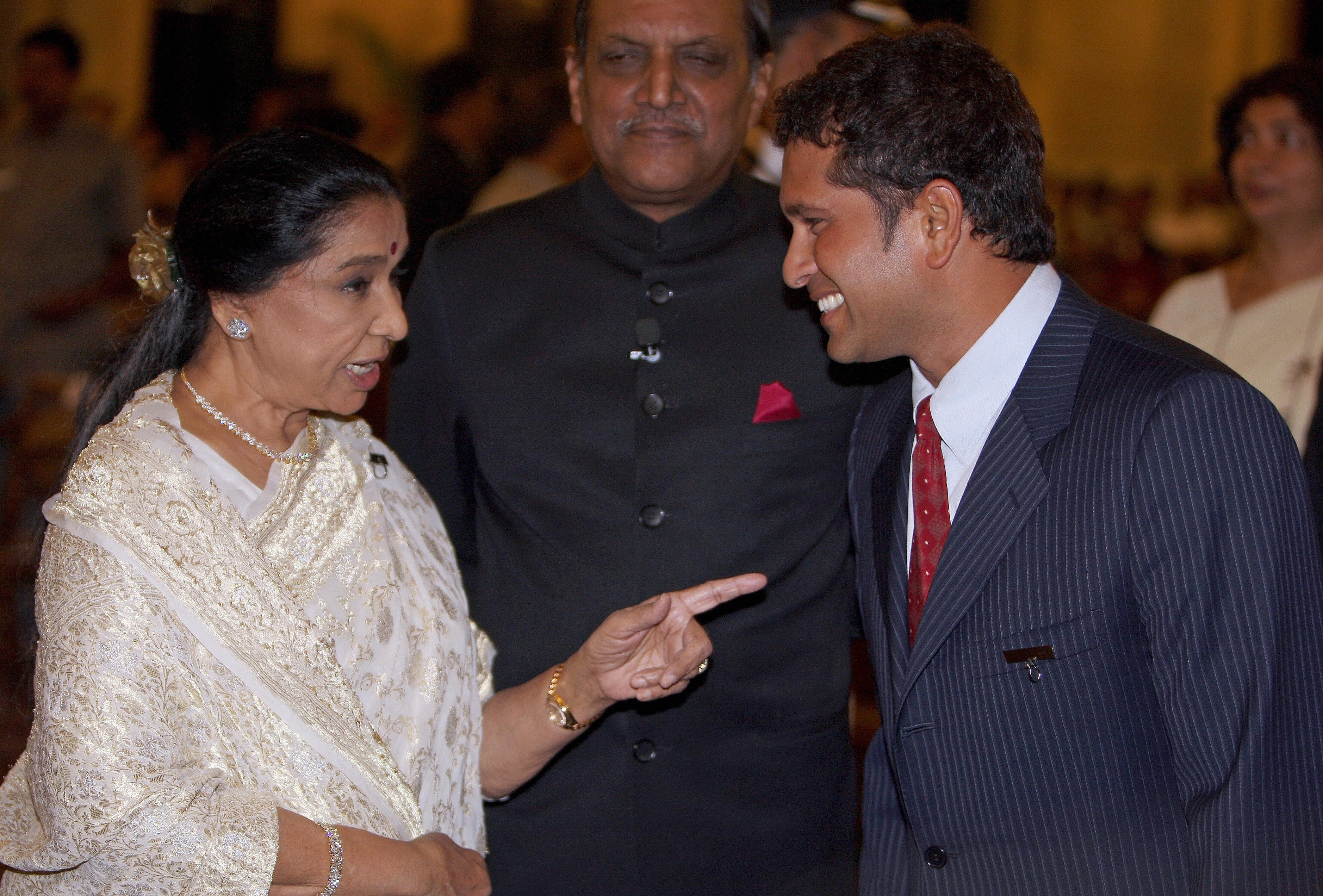 Asha Bhosle talks with cricketer Sachin Tendulkar prior to the presentation of the 'Padma Awards 2008' at the President House in New Delhi in May 2008