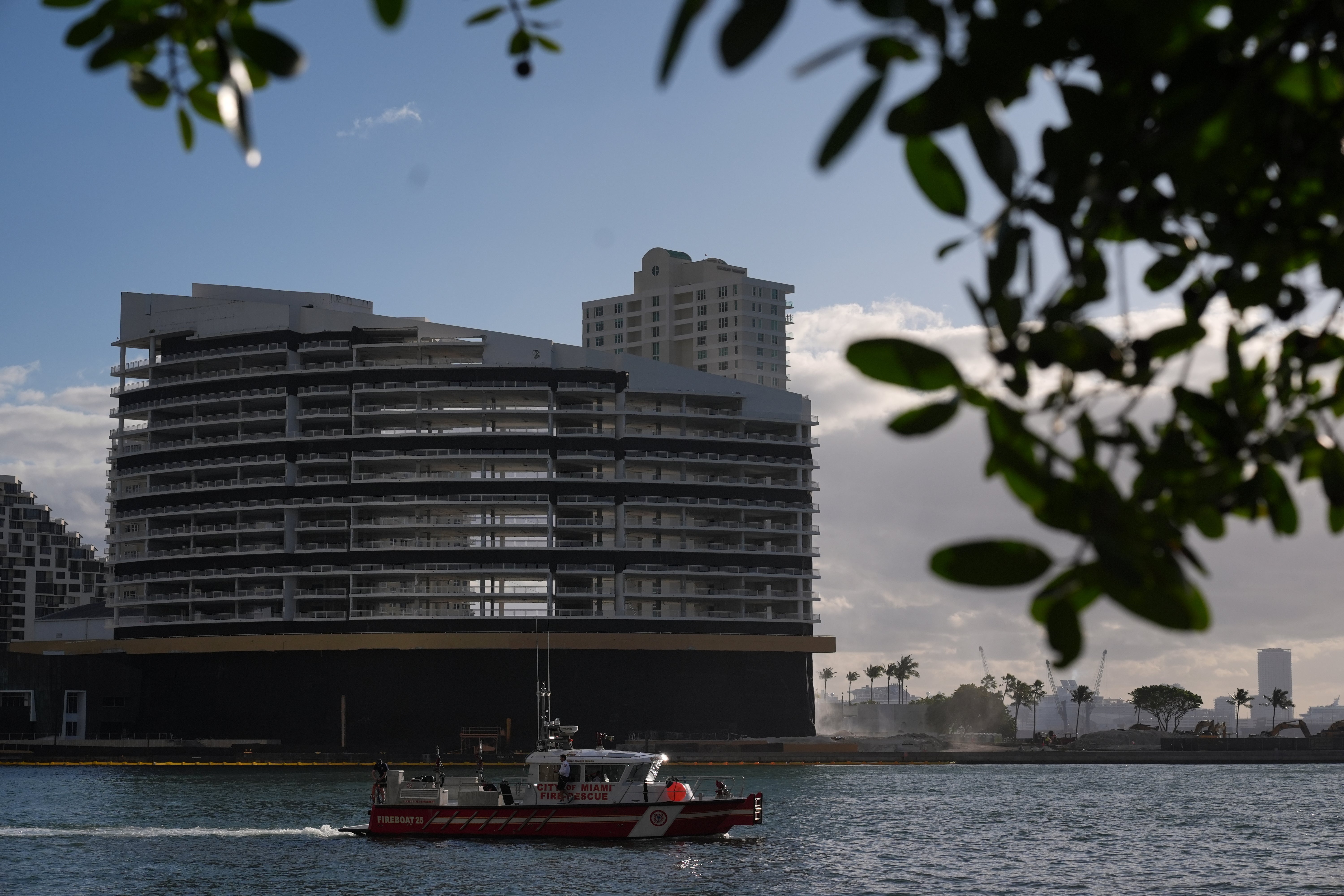 A City of Miami Fire-Rescue boat patrols in front of the former Mandarin Oriental Hotel on Brickell Key ahead of its controlled implosion