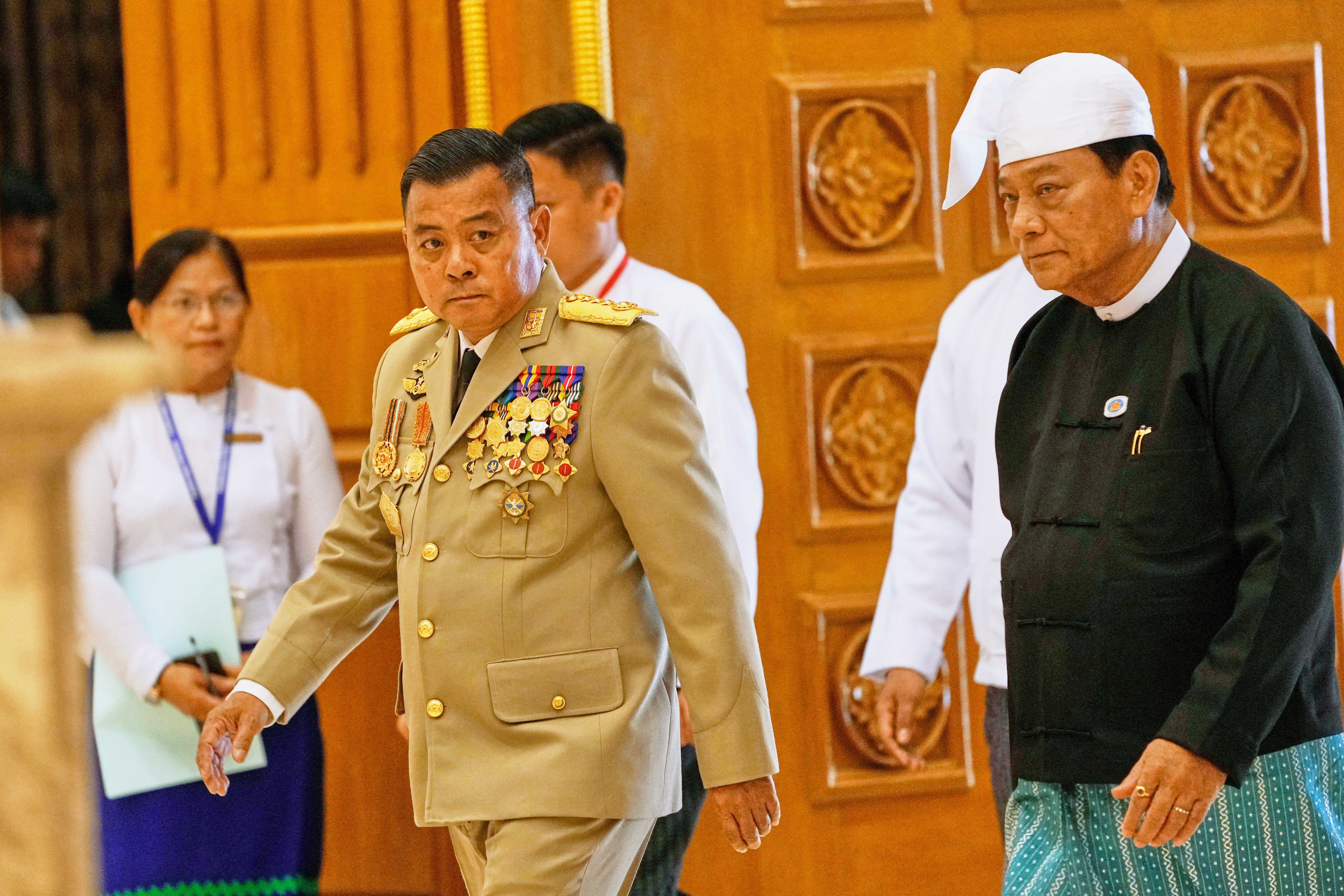 Commander-in-Chief Gen. Ye Win Oo, left, arrives for a sworn-in ceremony at Union parliament in Naypyitaw, Myanmar, Friday
