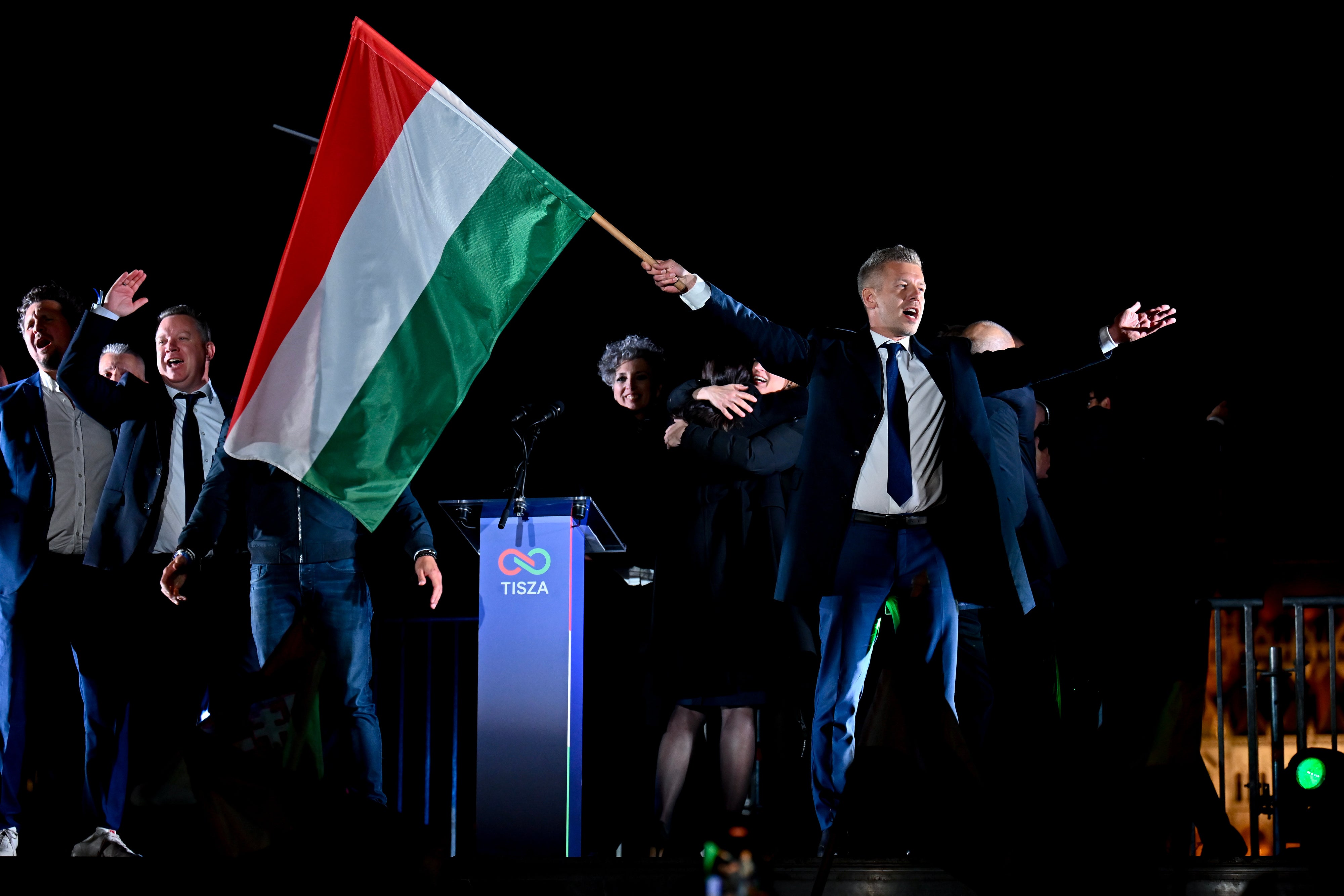 Peter Magyar, leader of the opposition Tisza party, waves the Hungarian flag following the announcement of the partial results of the parliamentary election, in Budapest.