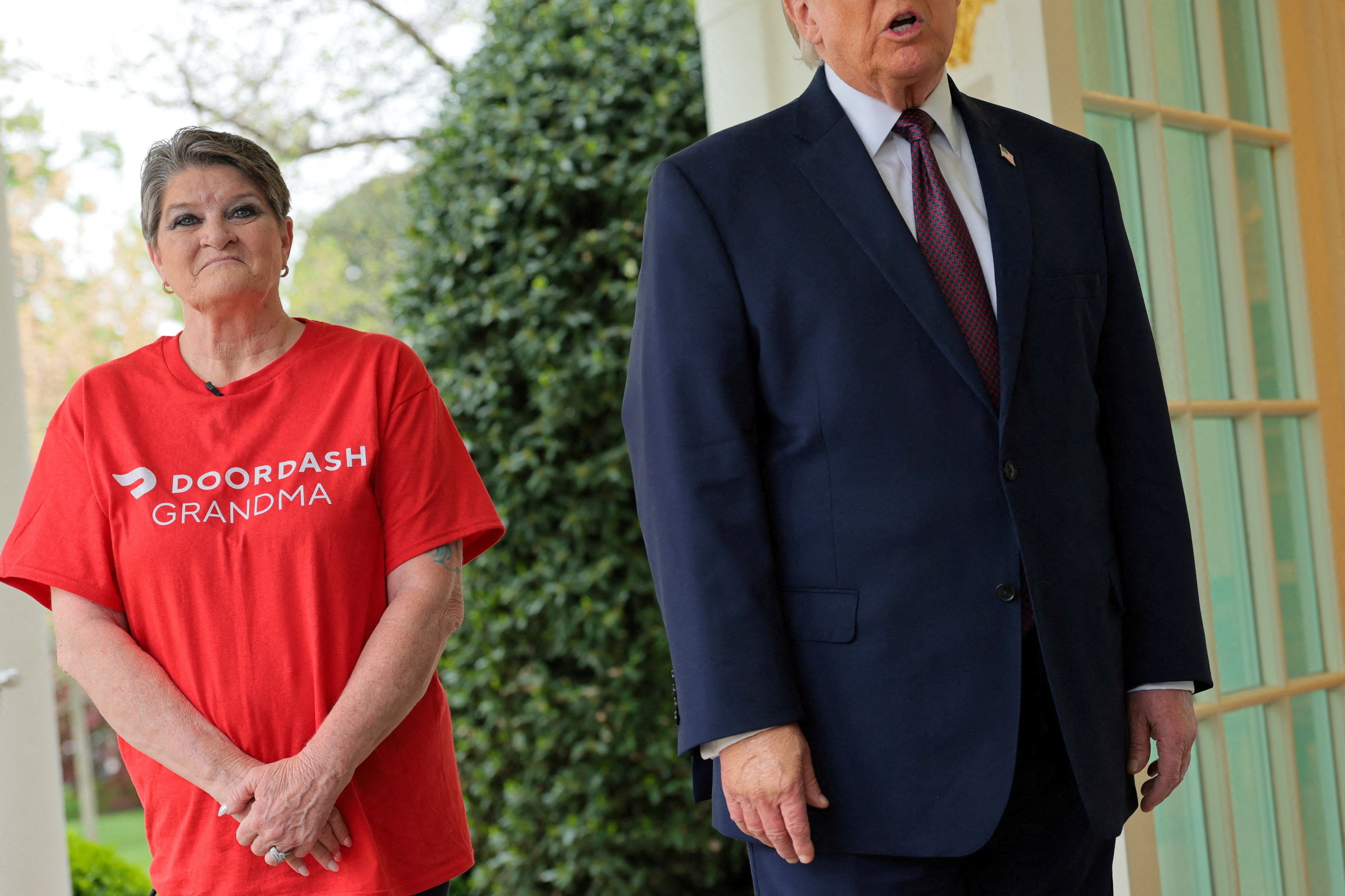 Simmons stood awkwardly by Trump's side as he took a range of questions from reporters