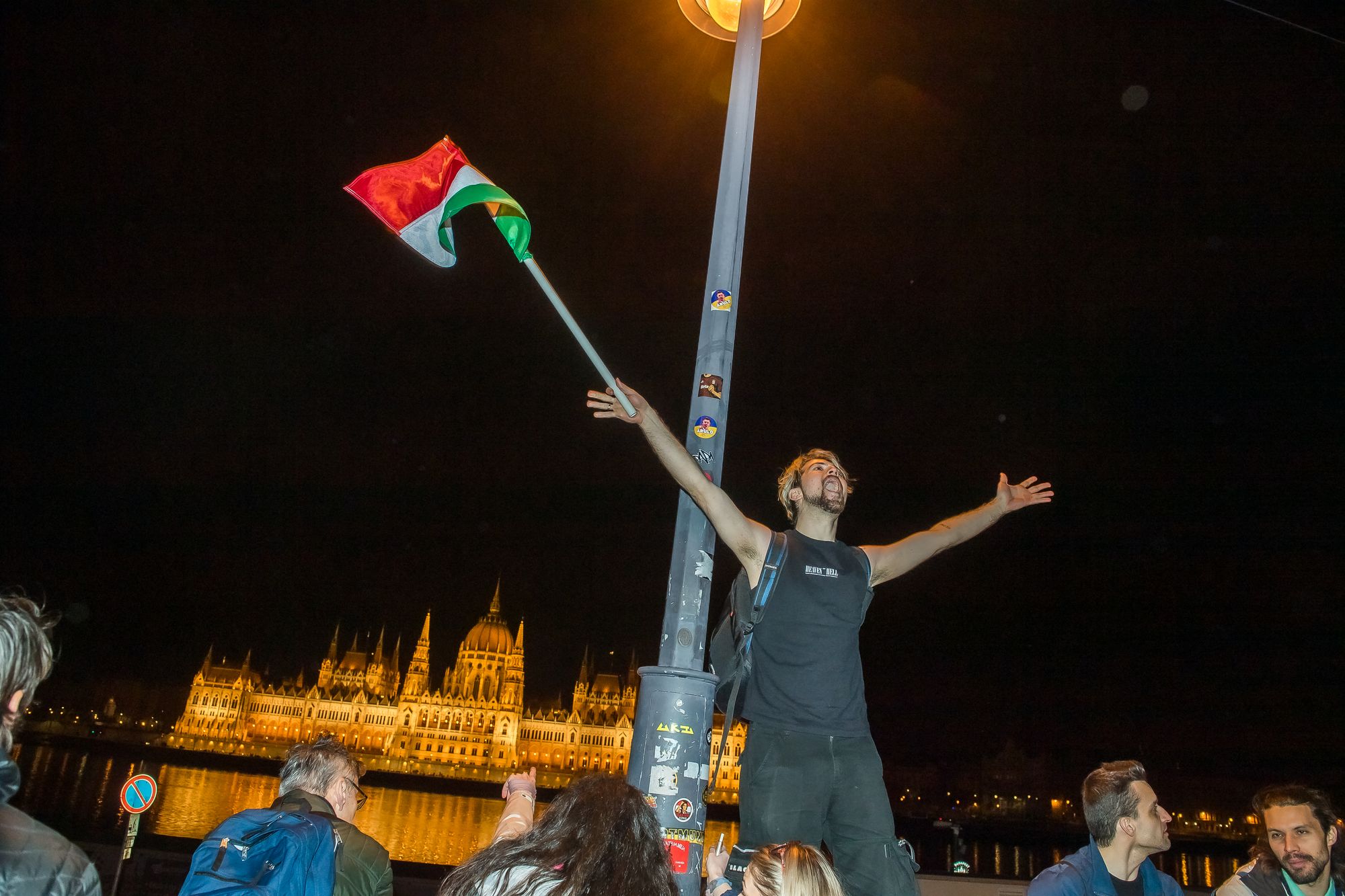 People celebrate in the streets after Hungarian Prime Minister Viktor Orban conceded defeat to Peter Magyar, leader of the pro-European conservative TISZA party, in Budapest, on April 12, 2026