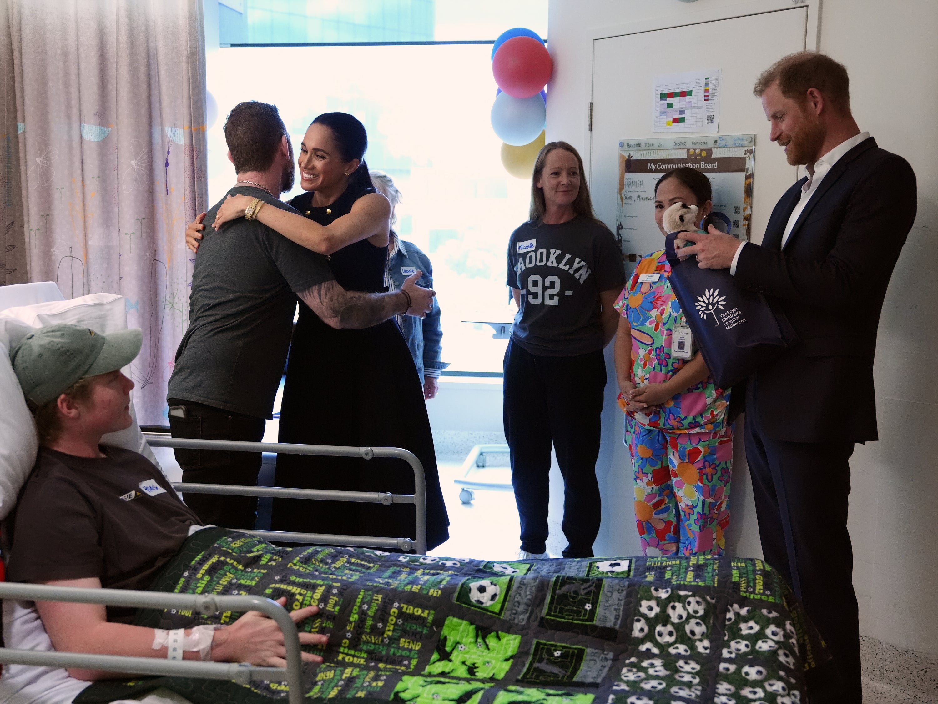 Britain's Prince Harry and Meghan Markle, the Duke and Duchess of Sussex, meet patient Hamish and family members on the Adolescent Oncology and Rehabilitation ward during a visit to the Royal Children's Hospital Melbourne, Australia Tuesday, April 14, 2026. (Jonathan Brady/Pool Photo via AP)