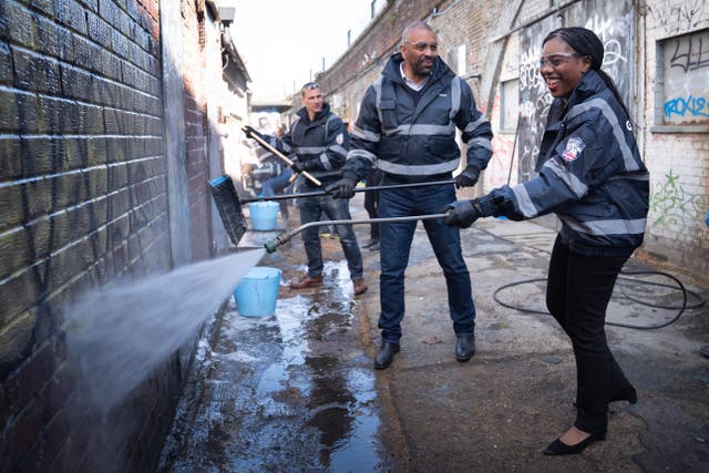 Conservative Party leader Kemi Badenoch joined by then shadow housing secretary James Cleverly help to clean graffiti off a wall in Herne Hill, south London, while on the party´s campaign trail for May’s local elections