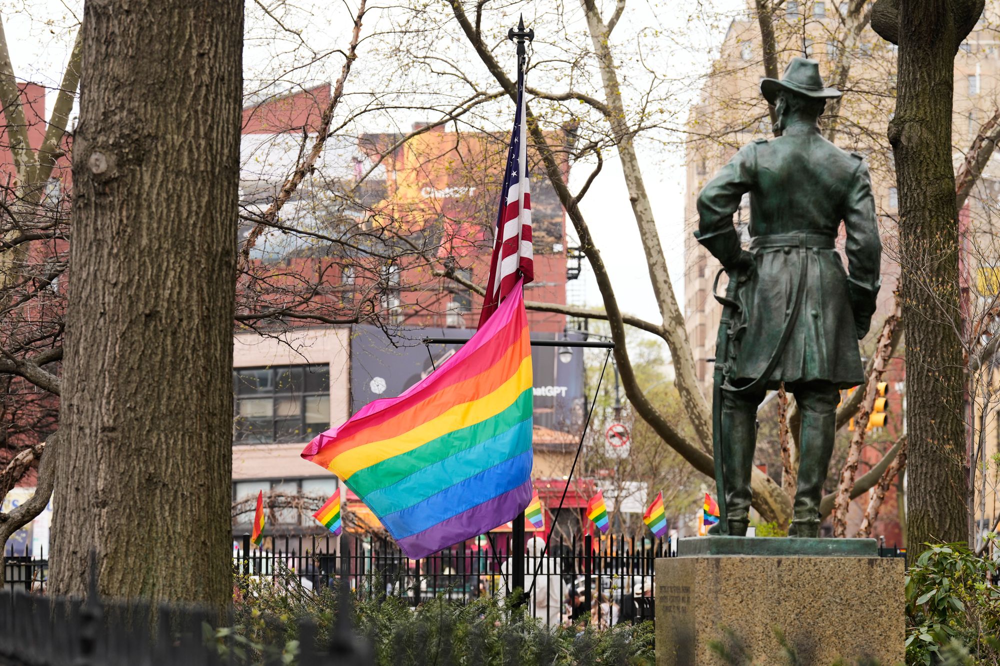 A rainbow Pride flag flies with an American flag at the Stonewall National Monument in New York, Monday, April 13, 2026