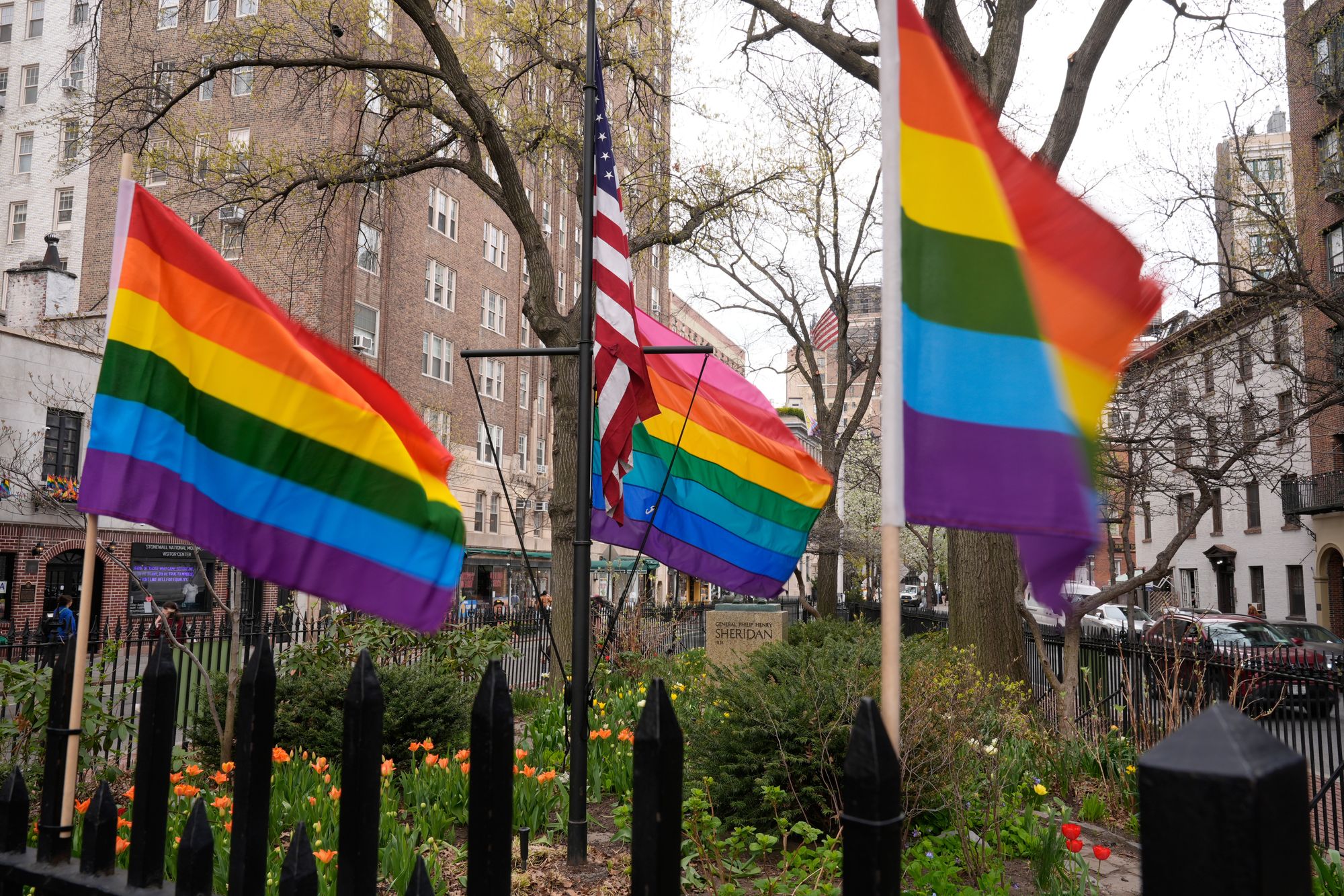 Small rainbow Pride flags are displayed near a flagpole with a larger Pride flag at the Stonewall National Monument in New York, Monday, April 13, 2026. (AP Photo/Seth Wenig)
