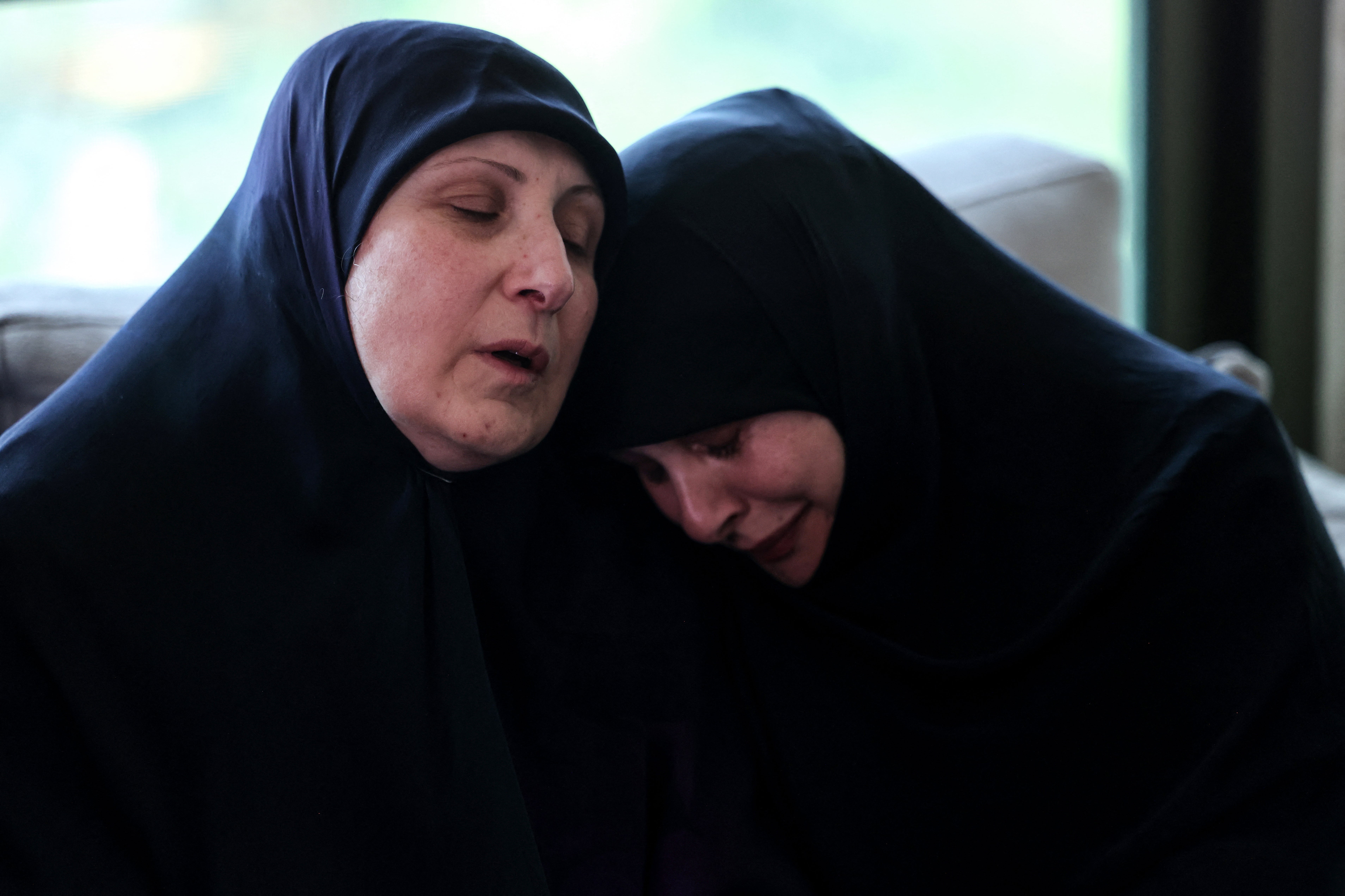 Ahlam Badawi (left), the mother of killed paramedic Hassan Badawi, receives condolences at her home in the town of Bchamoun, south of Beirut, on Monday