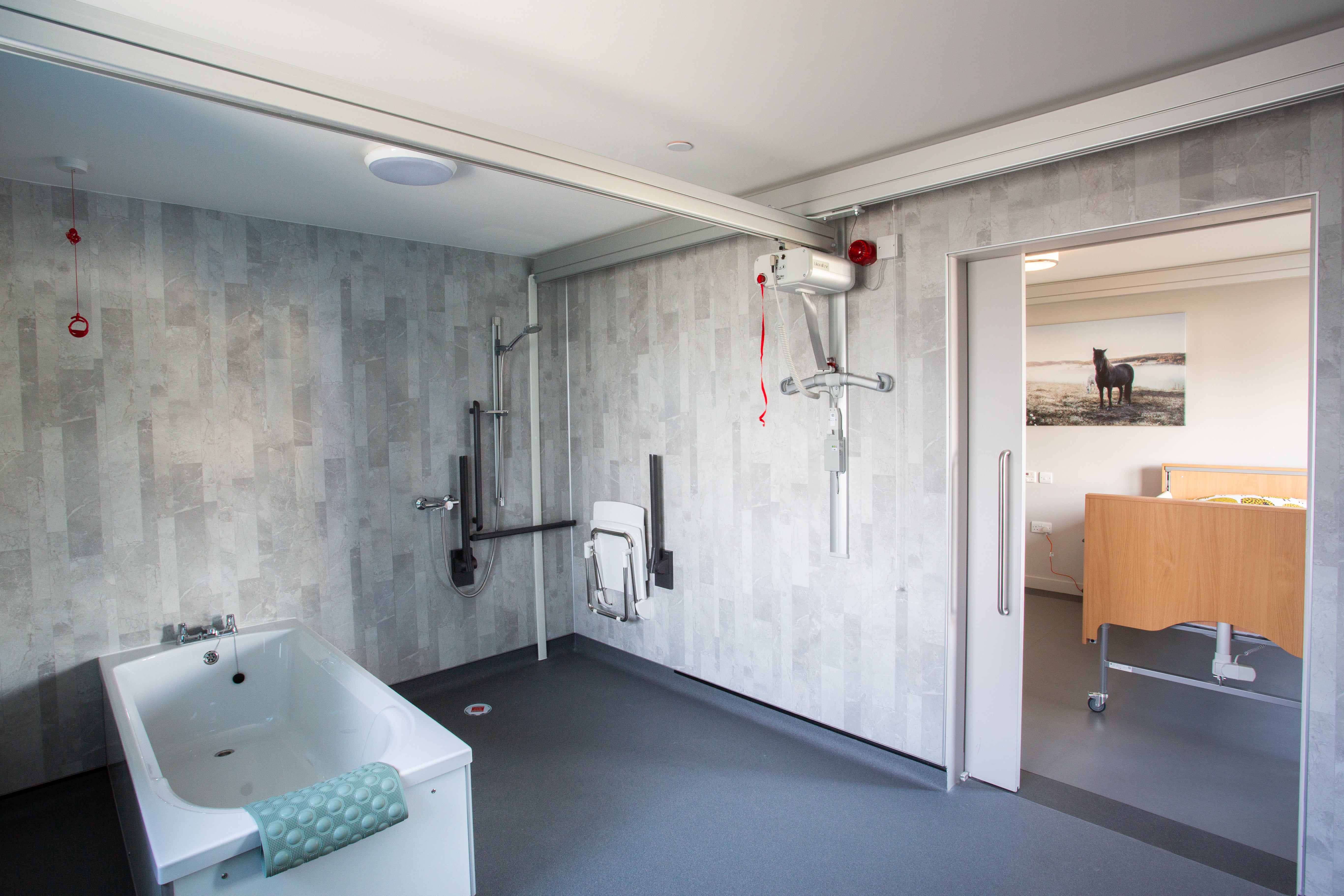 Track hoists allow access into a large wet room at the Jordan Suite