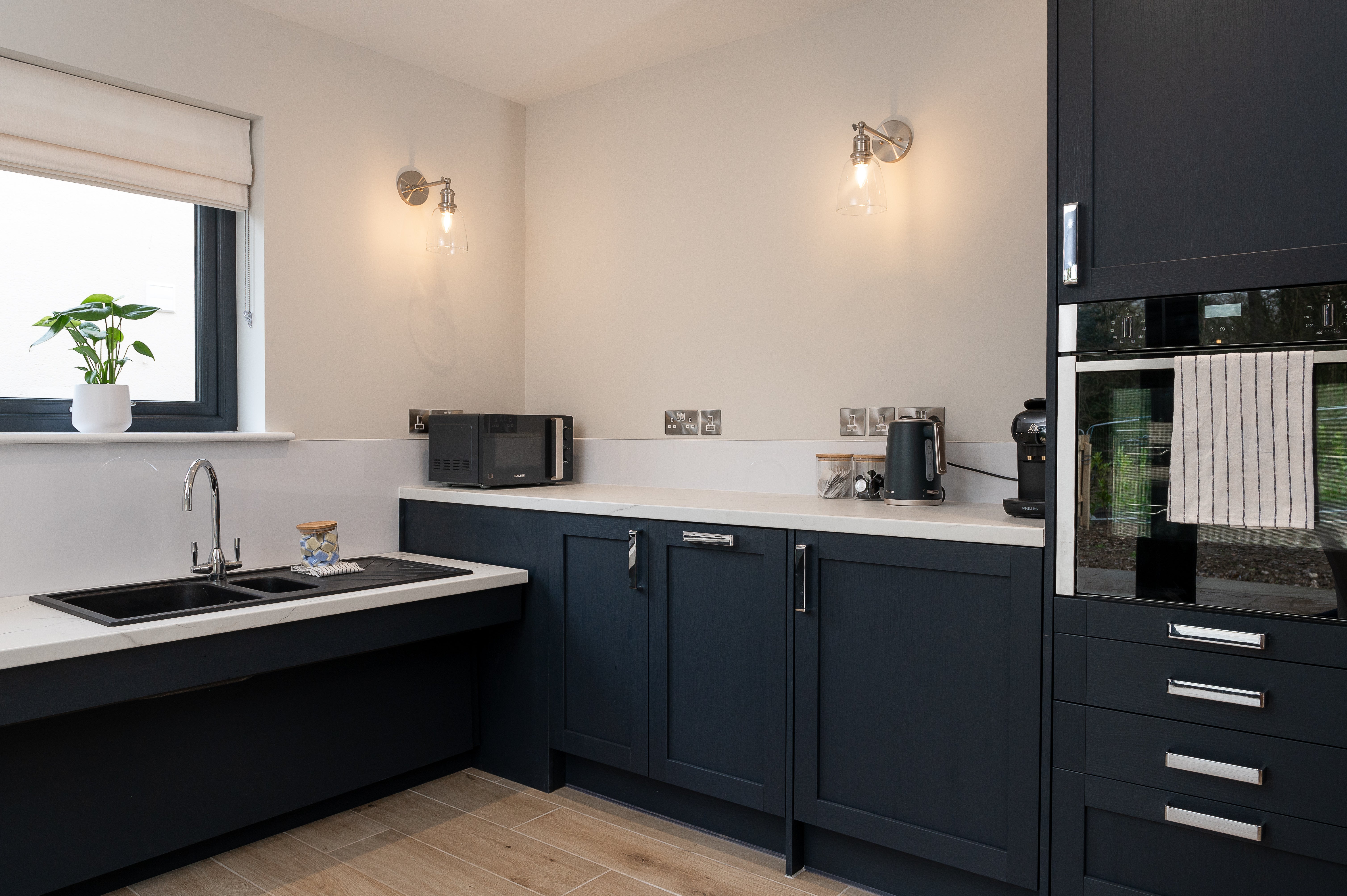 Rose Cottage has a practical kitchen with French doors that open onto the rear garden