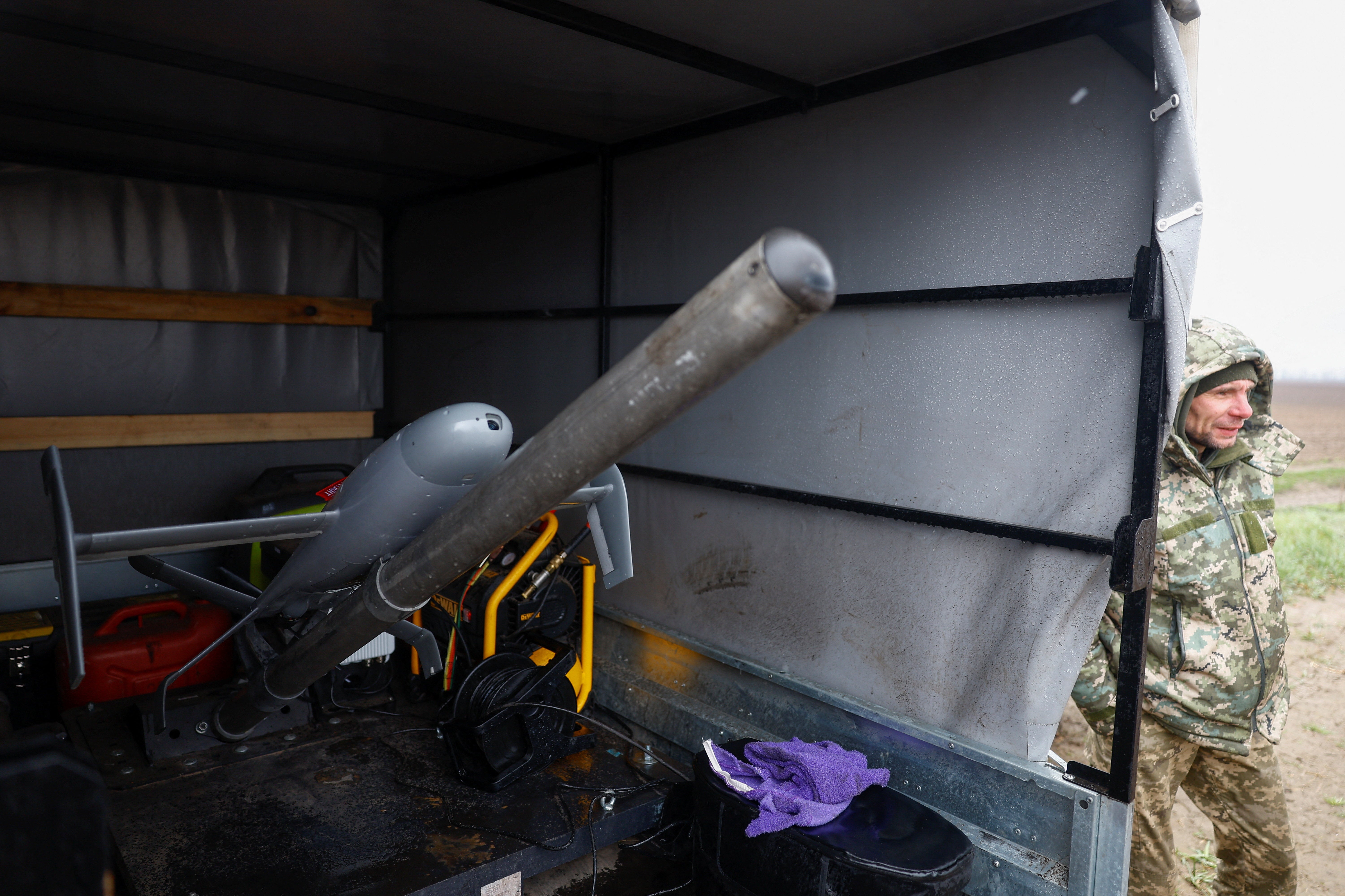 Ukrainian service member Anatolii stands next to an AS3 interceptor unmanned aerial vehicle during training in Ukraine