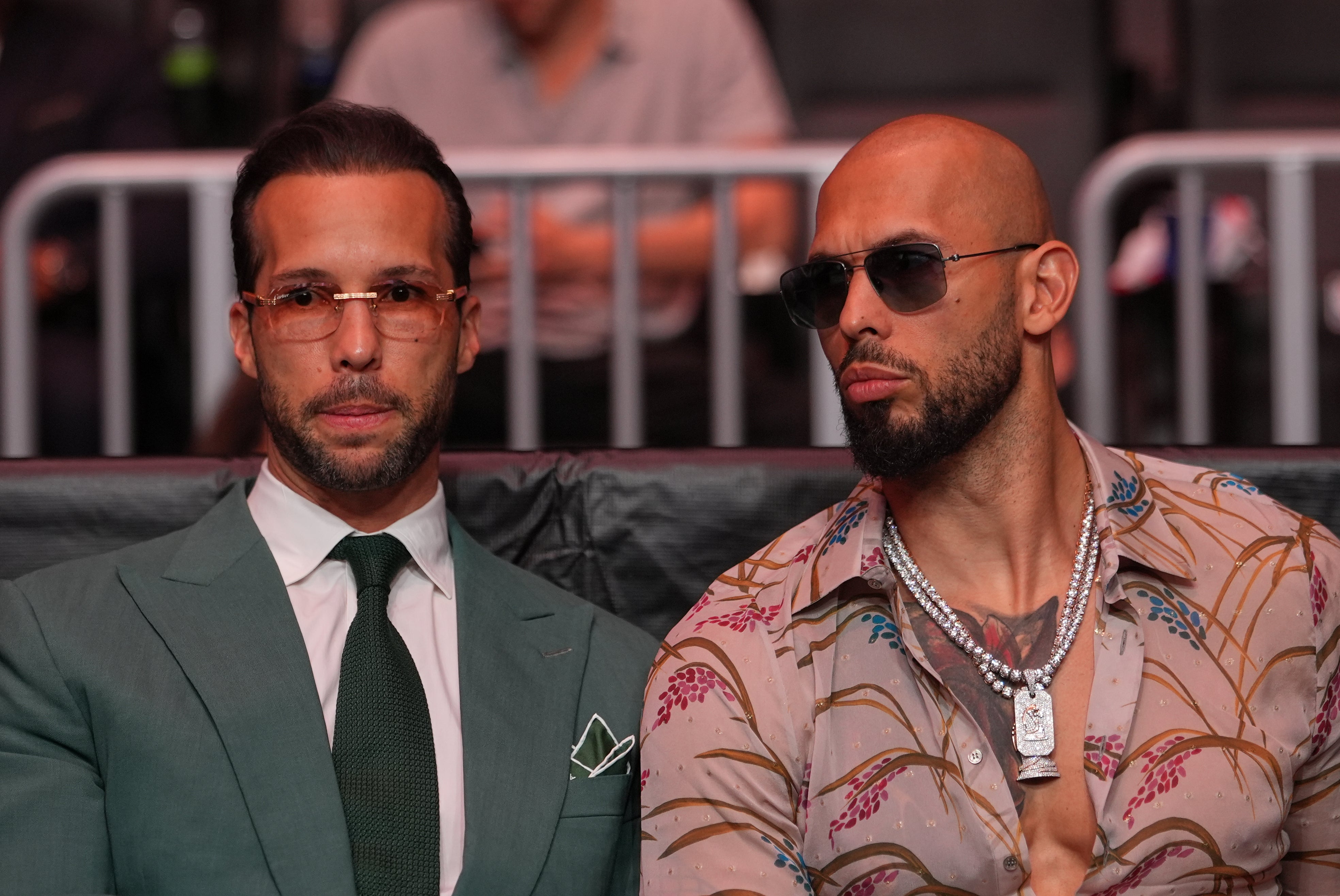 Tristan Tate (left) and Andrew Tate (right), pictured here at UFC 327, are facing multiple investigations, including allegations of rape and human trafficking, in multiple countries