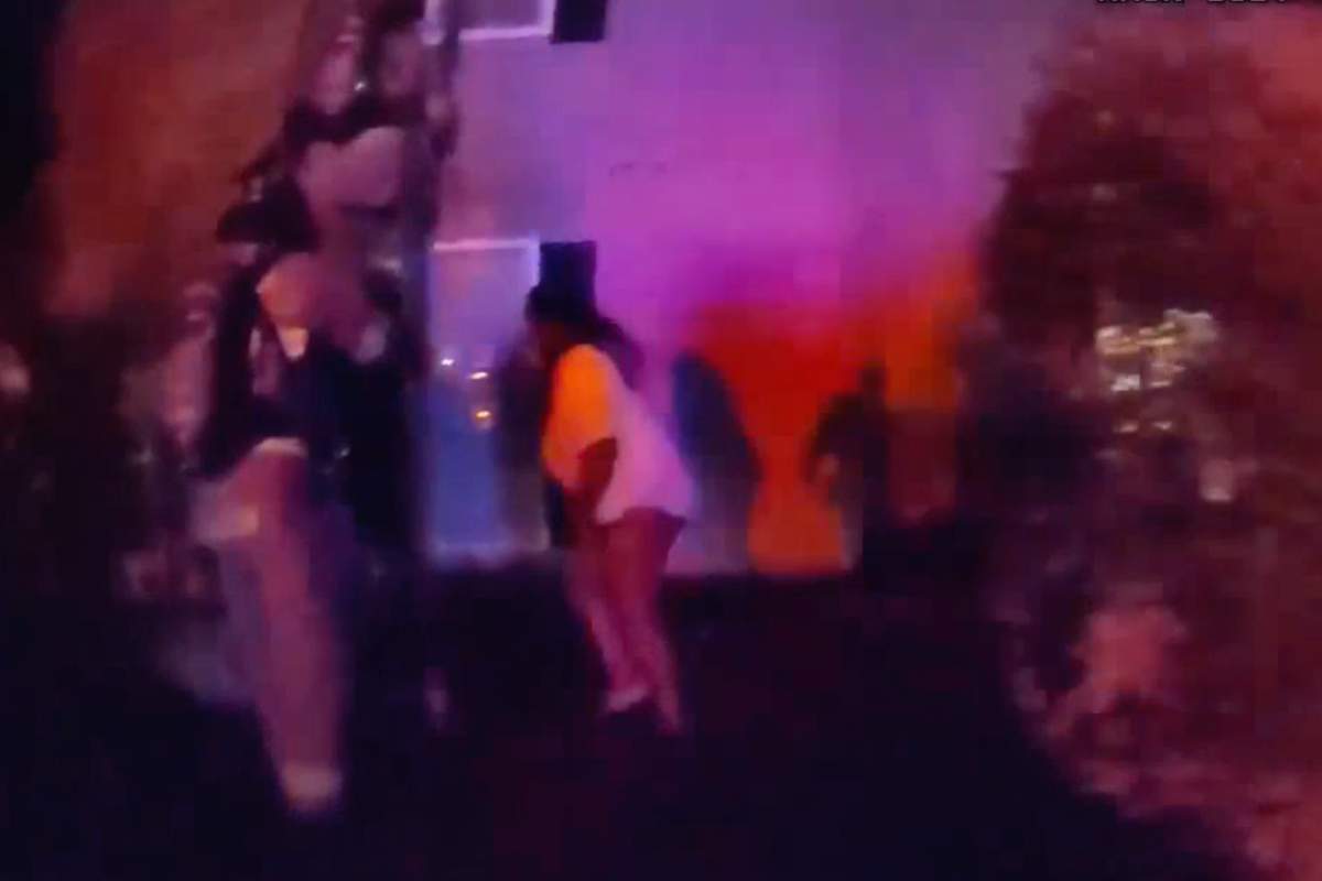 Desperate mother throws children from burning third-story building to officers below