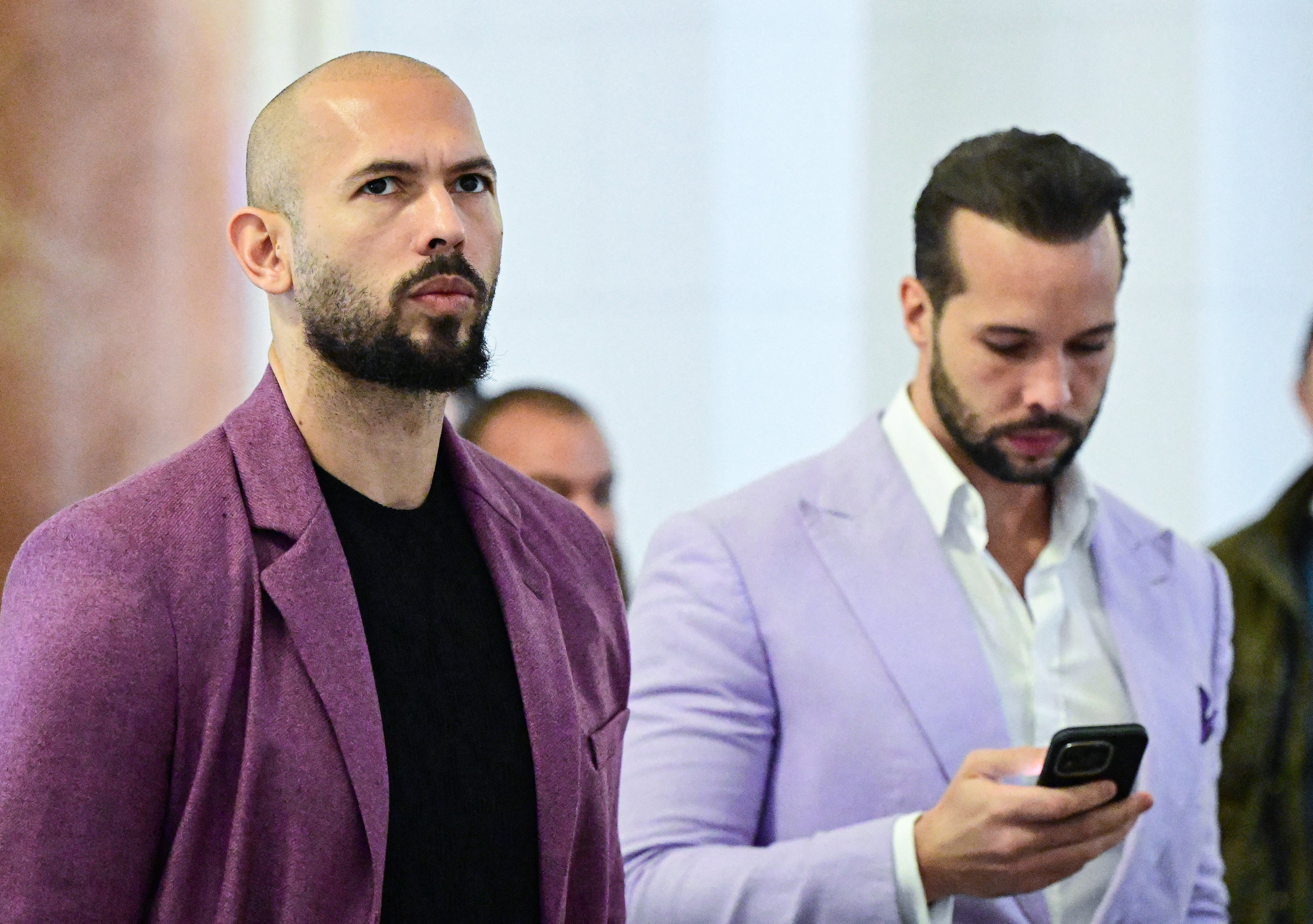 Influencer and self-described misogynist Andrew Tate Andrew Tate (left) and his brother, Tristan Tate, are seen in court in Bucharest, Romania, in 2024. They have faced numerous allegations, which they have denied