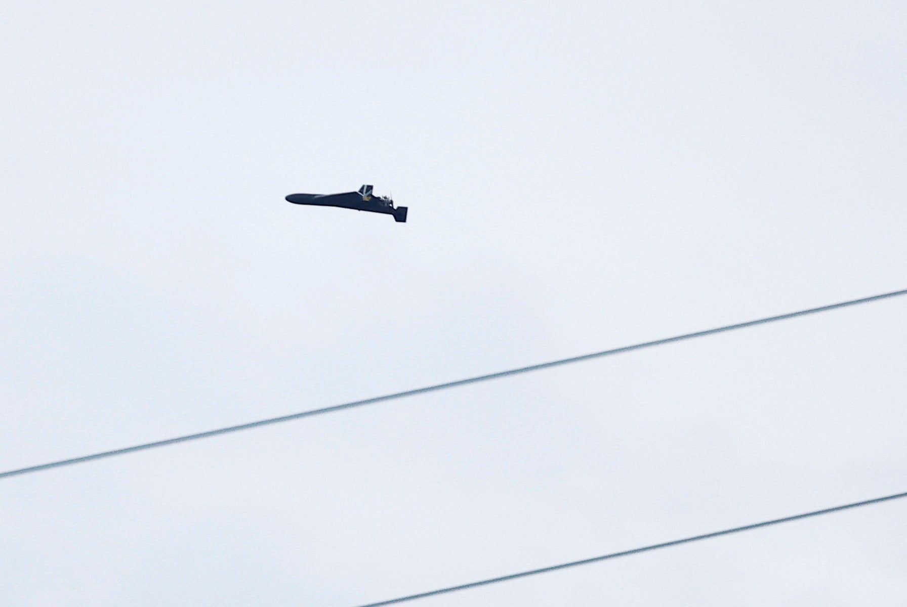 A Russian Geran 2 kamikaze drone seen on its trajectory to attack a Ukrainian apartment building