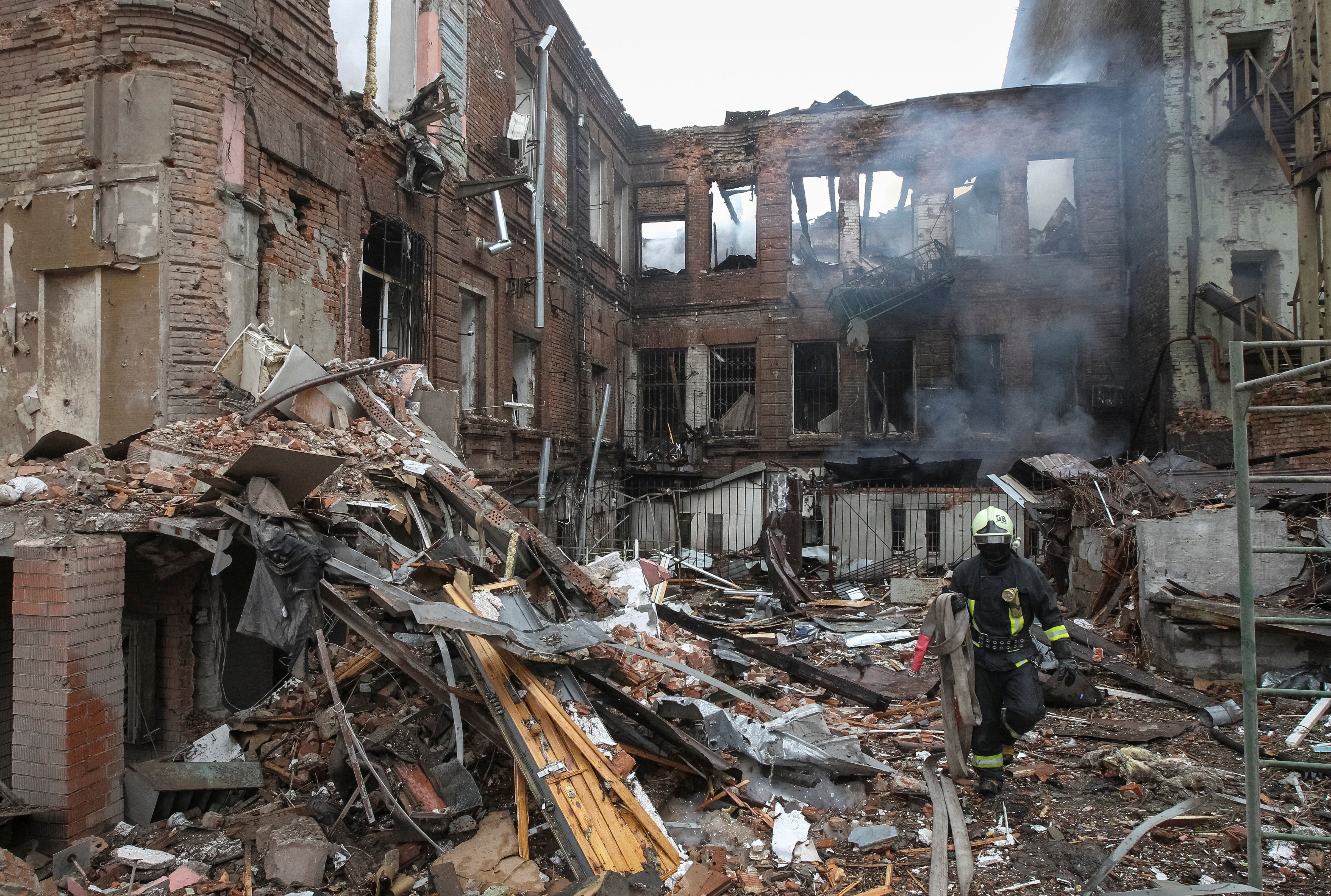 A rescuer works at a site of apartment buildings hit by a Russian missile and drone strike in Dnipro