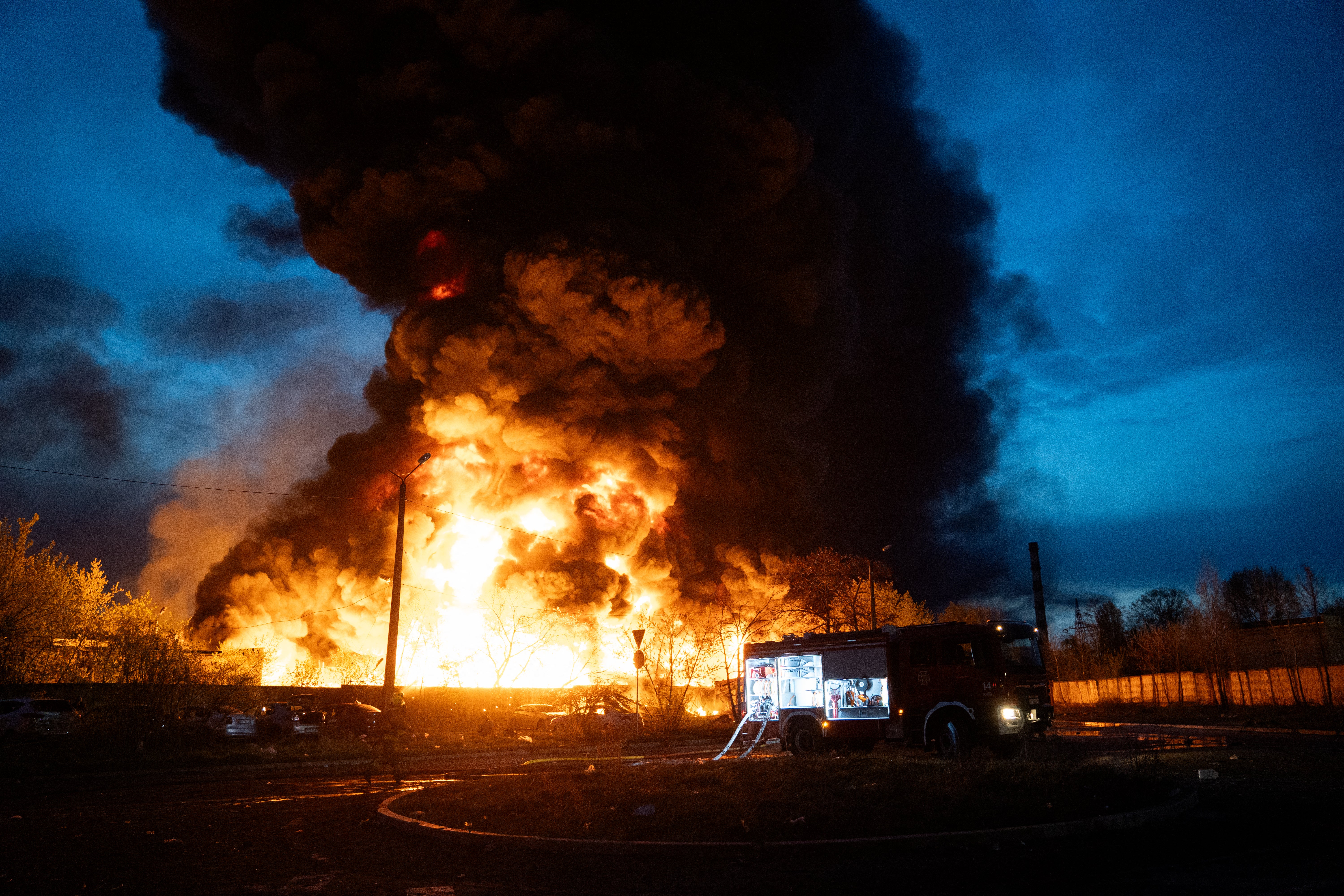 Firefighters extinguish a blaze at the site of recycling materials following a Russian strike in Kyiv