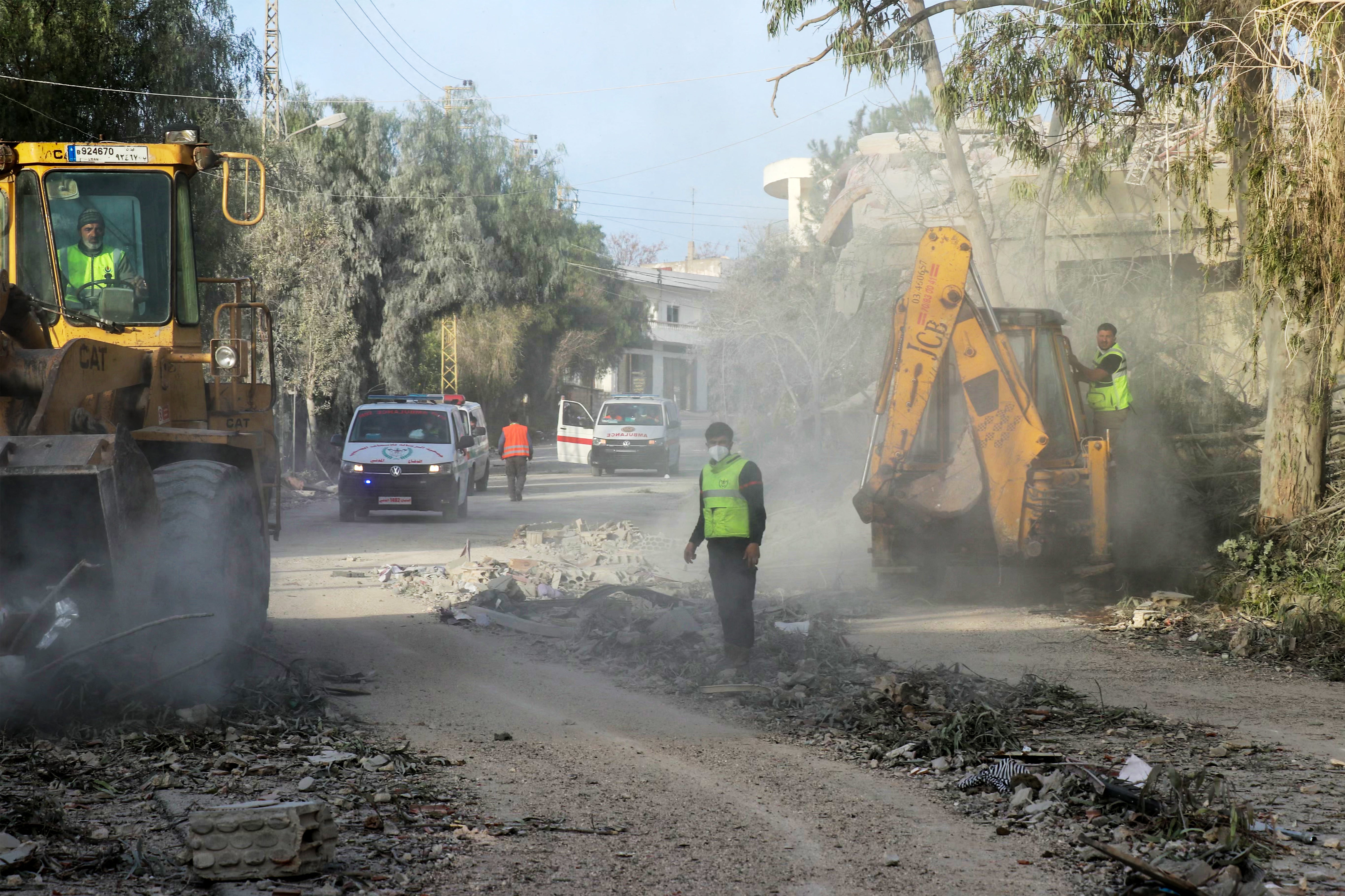 First responders gather at the site of an Israeli airstrike that targeted the southern Lebanese village of Srifa on April 14