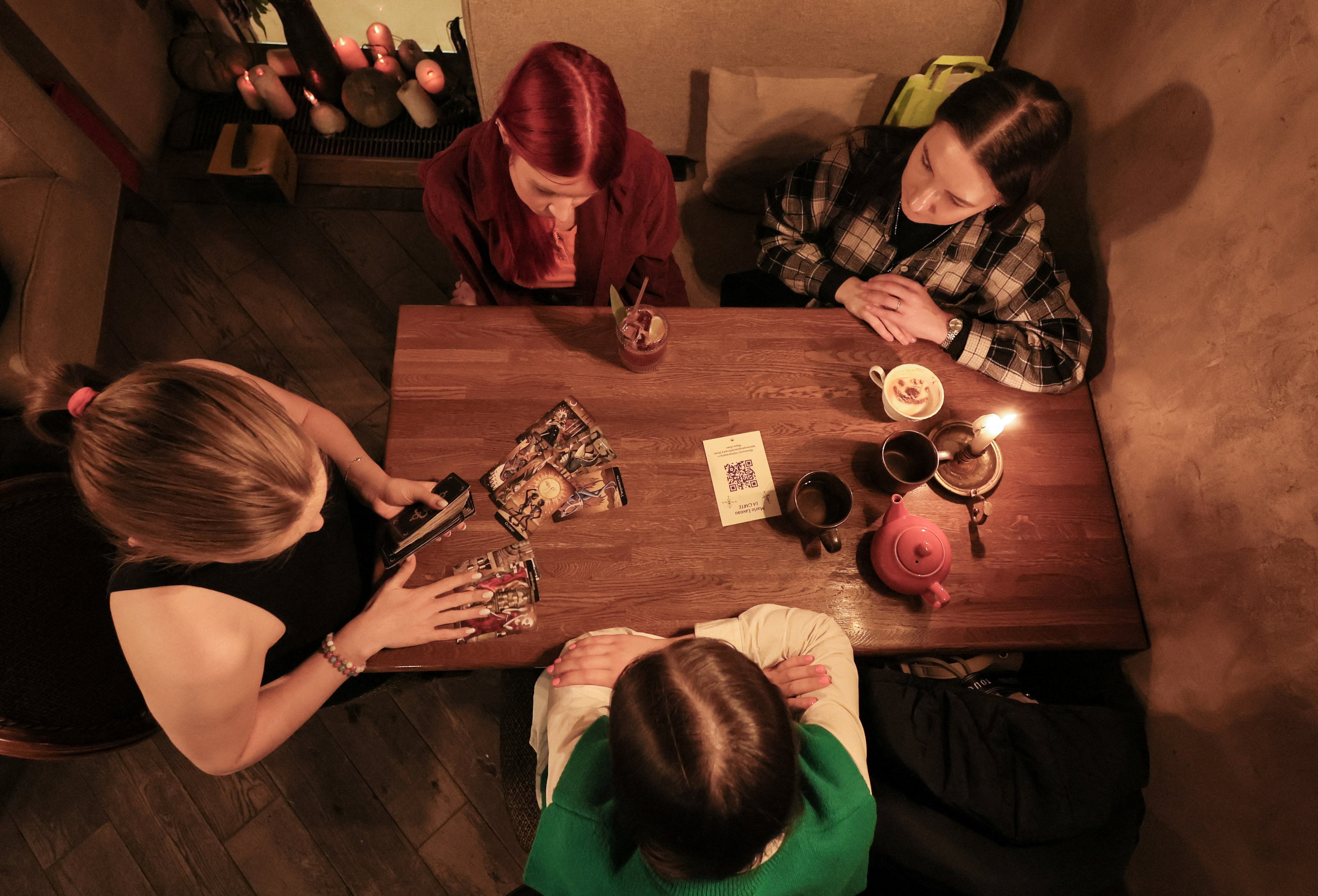 A fortune teller lays out Tarot cards on a table in a bar in Moscow