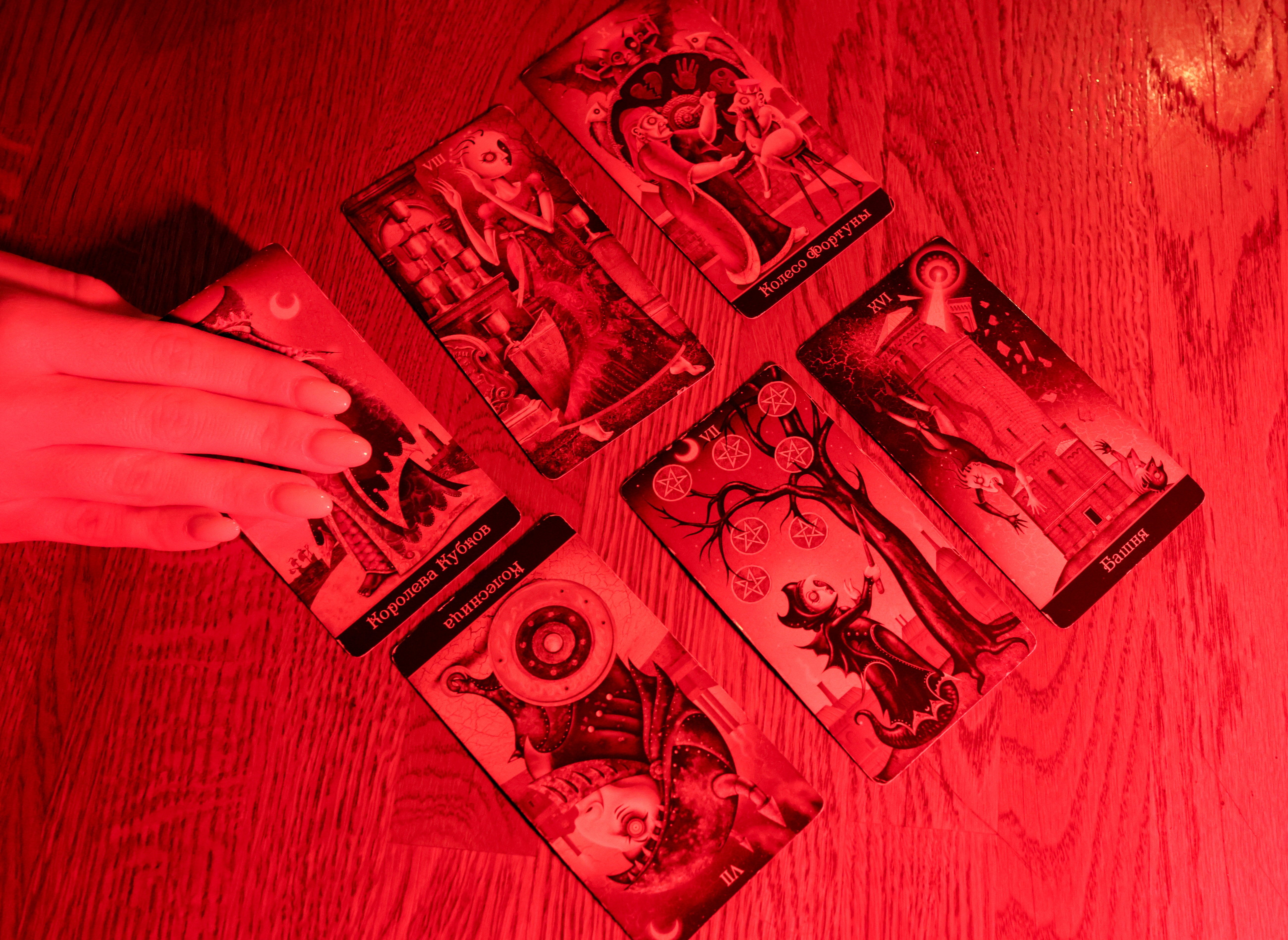 Fortune teller Arina Frants lays out Tarot cards on a table in the voodoo-themed bar Marie Laveau in Moscow