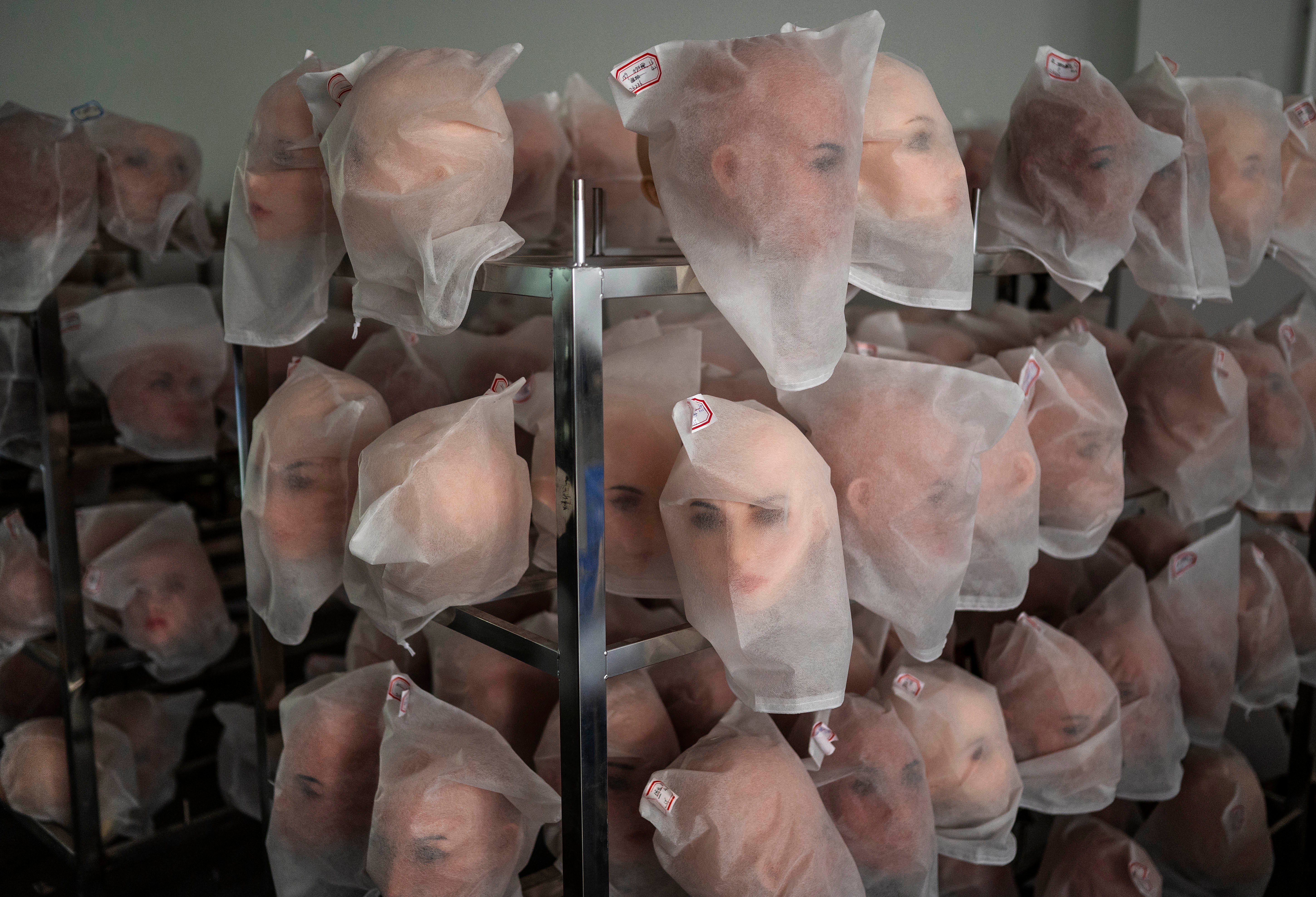 Heads for silicone sex dolls are seen on racks in the production area at a factory for WM Dolls (Getty)