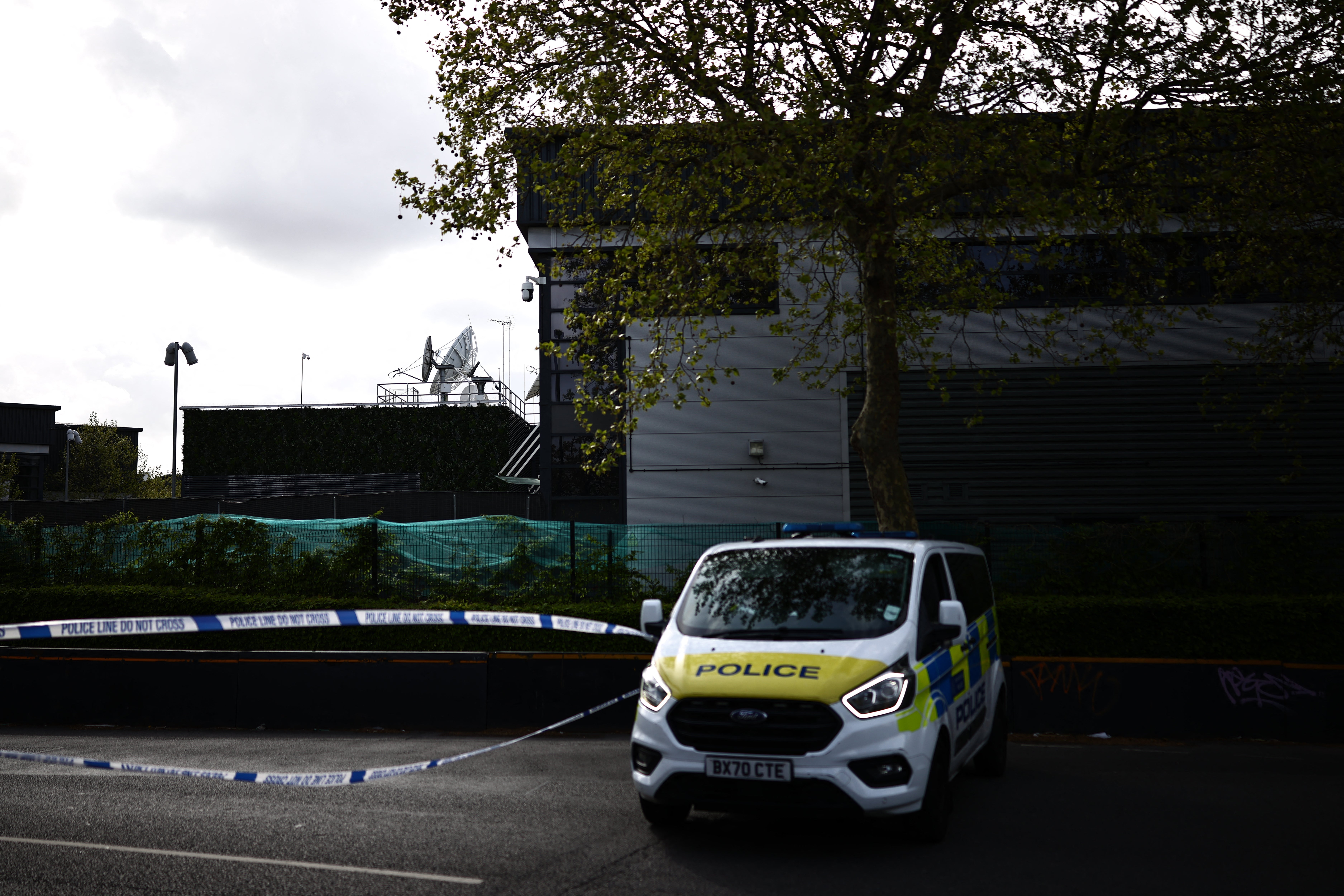 Police van parked outside of a warehouse park housing offices of a Persian-language TV station, Iran International, in Wembley