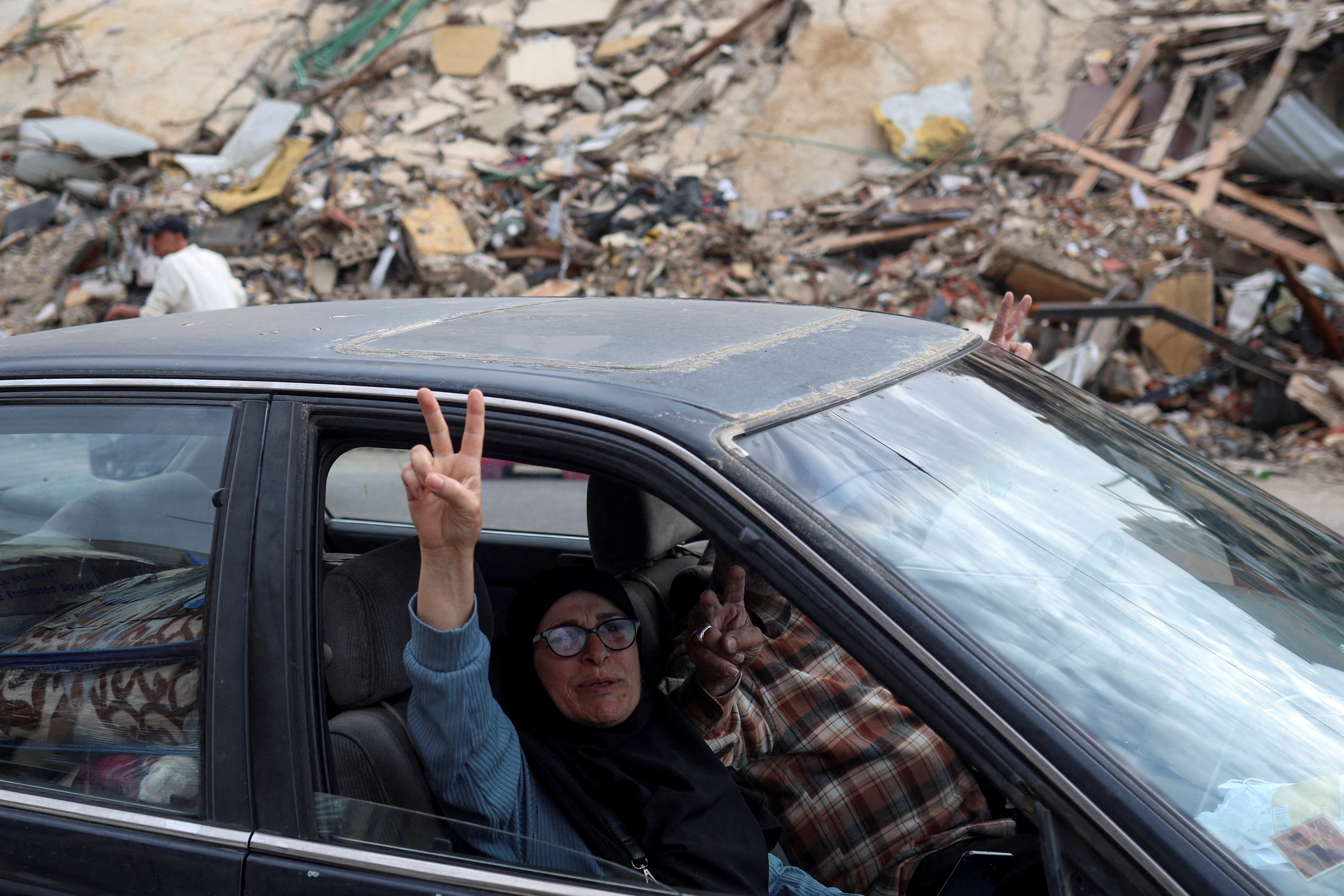 A couple gestures from a car as they return to their home, after a 10-day ceasefire between Lebanon and Israel went into effect, in the southern suburbs of Beirut, Lebanon, April 17, 2026