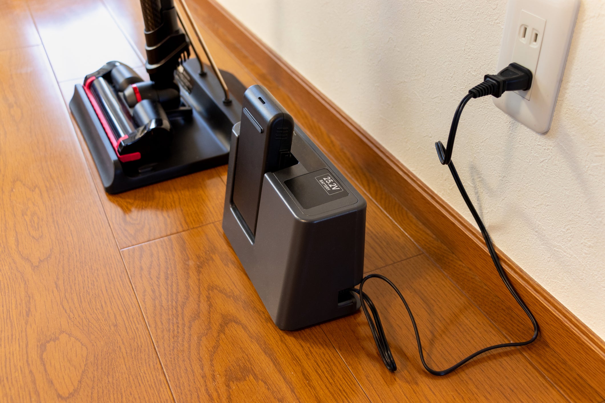 Charging the battery of a cordless vacuum cleaner.