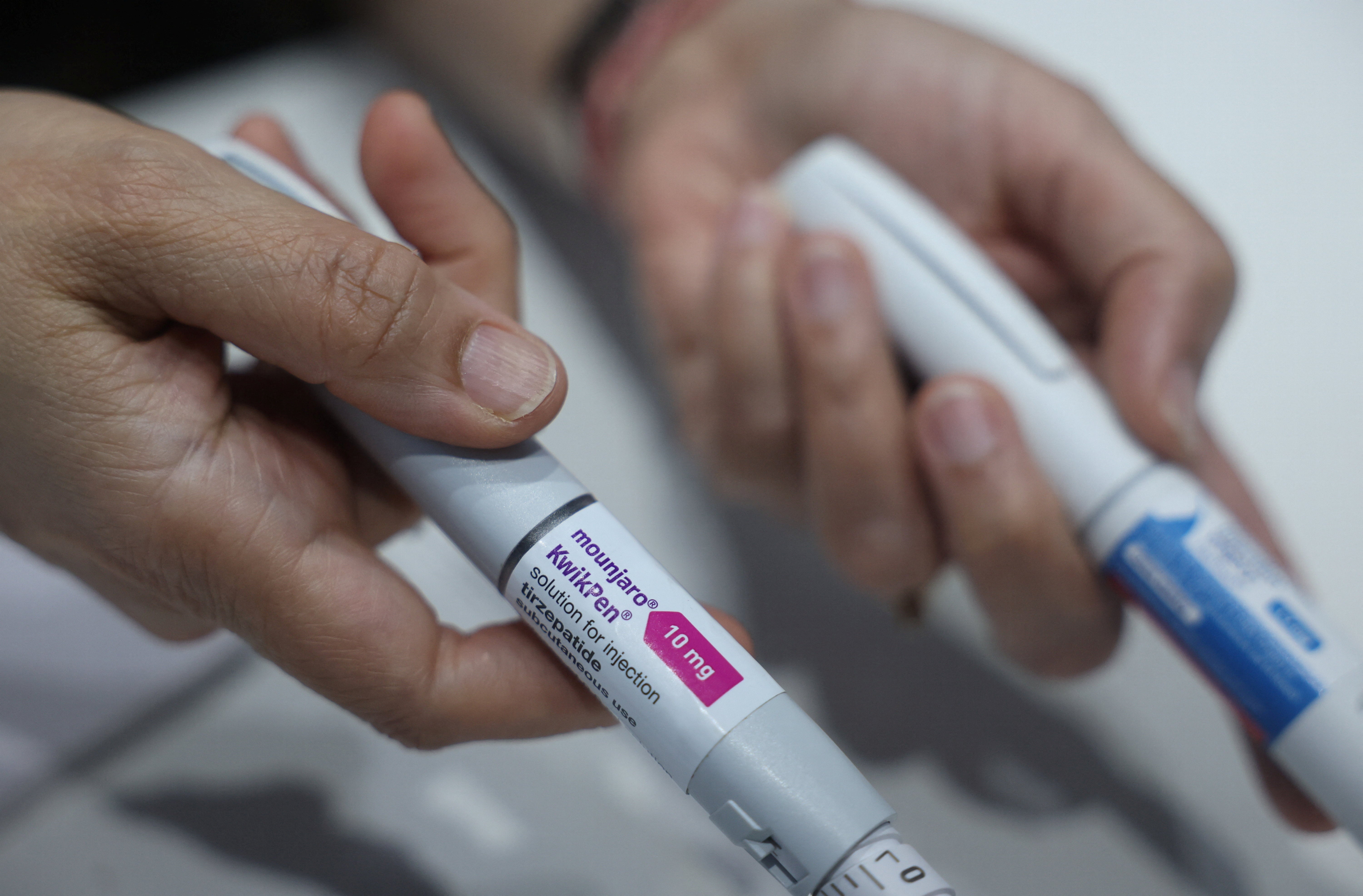 A doctor displays a Mounjaro injection used for weight loss procedures