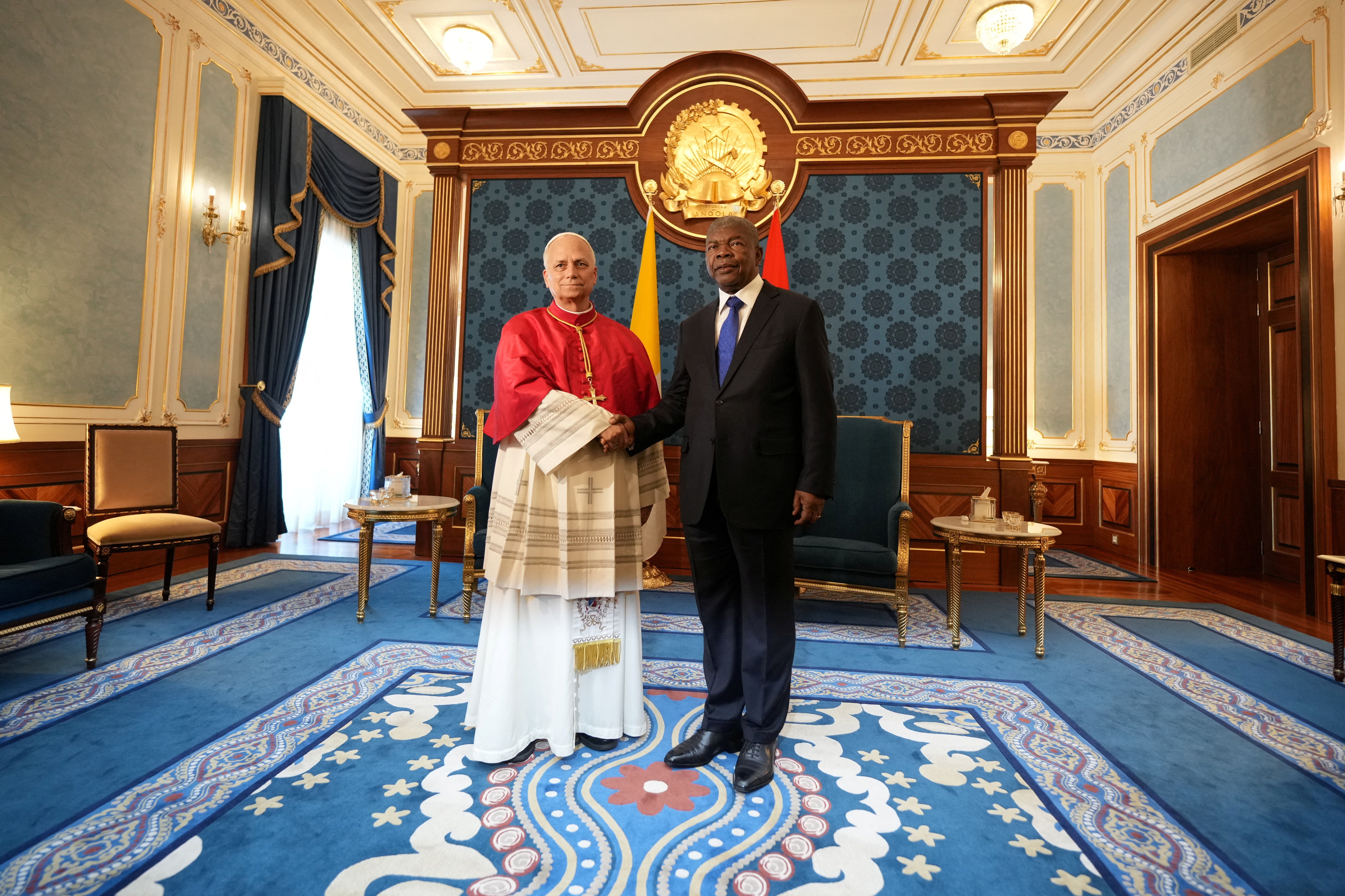 Pope Leo XIV shakes hands with Angola's President Joao Lourenco, during their meeting at the Presidential Palace in Luanda, Angola on Saturday