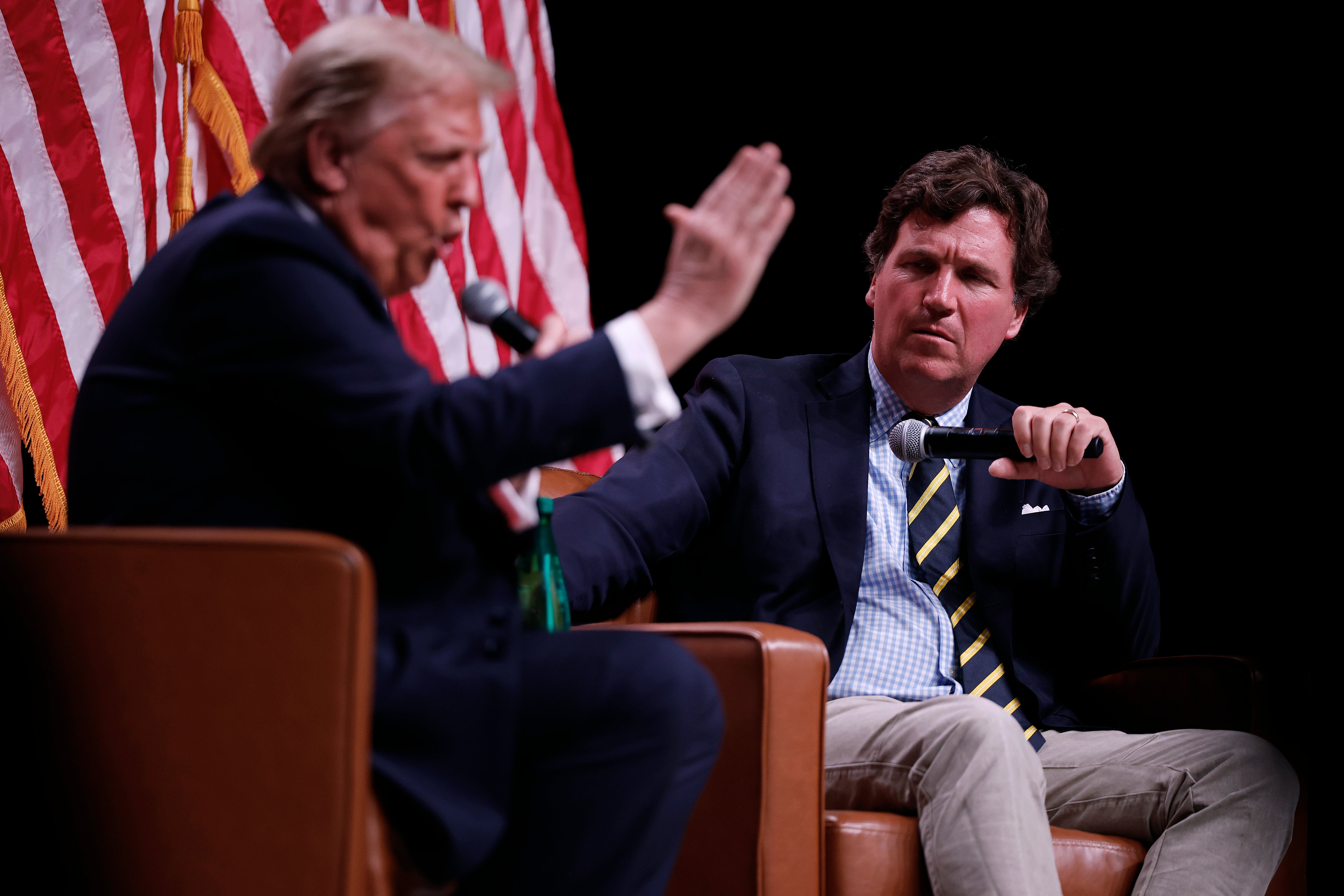 Trump sits for an interview with Carlson, during the podcaster’s live tour in 2024 (Getty)