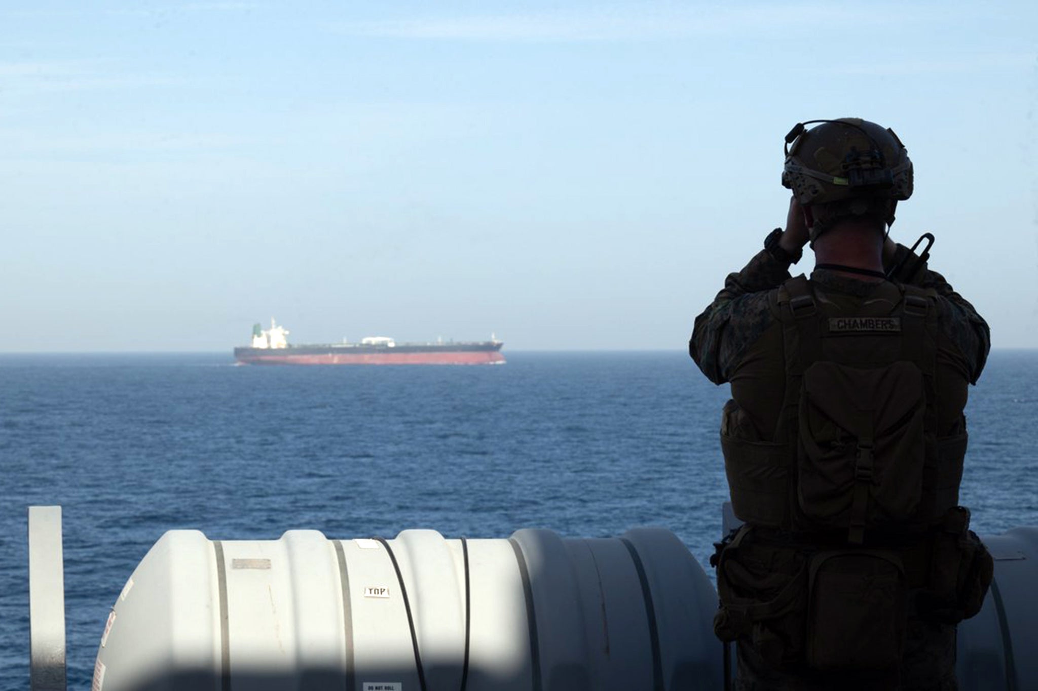 A US marine aboard the USS New Orleans monitors shipping during the US maritime blockade