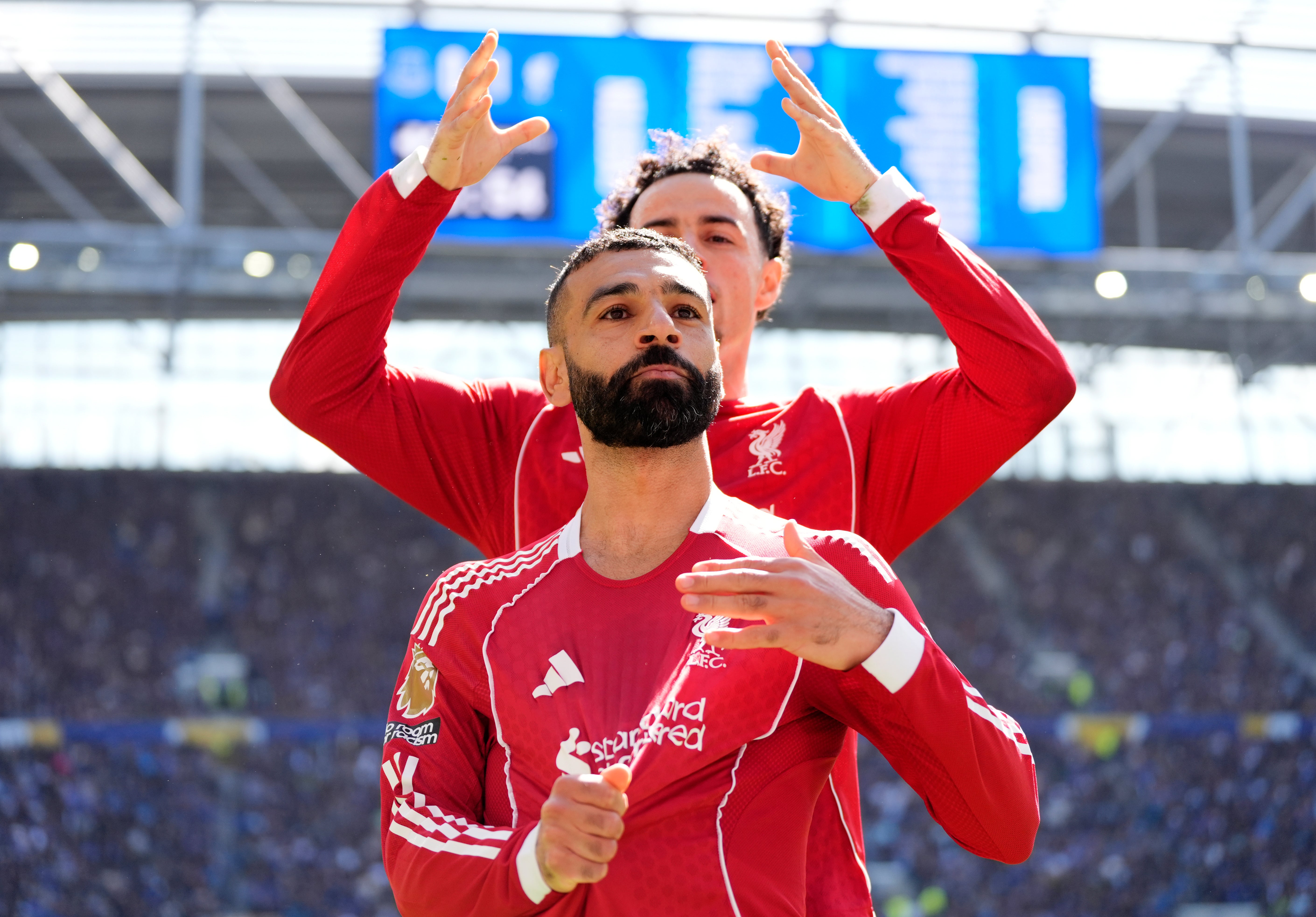 Liverpool's Curtis Jones mimes crowning Mohamed Salah as he celebrates
