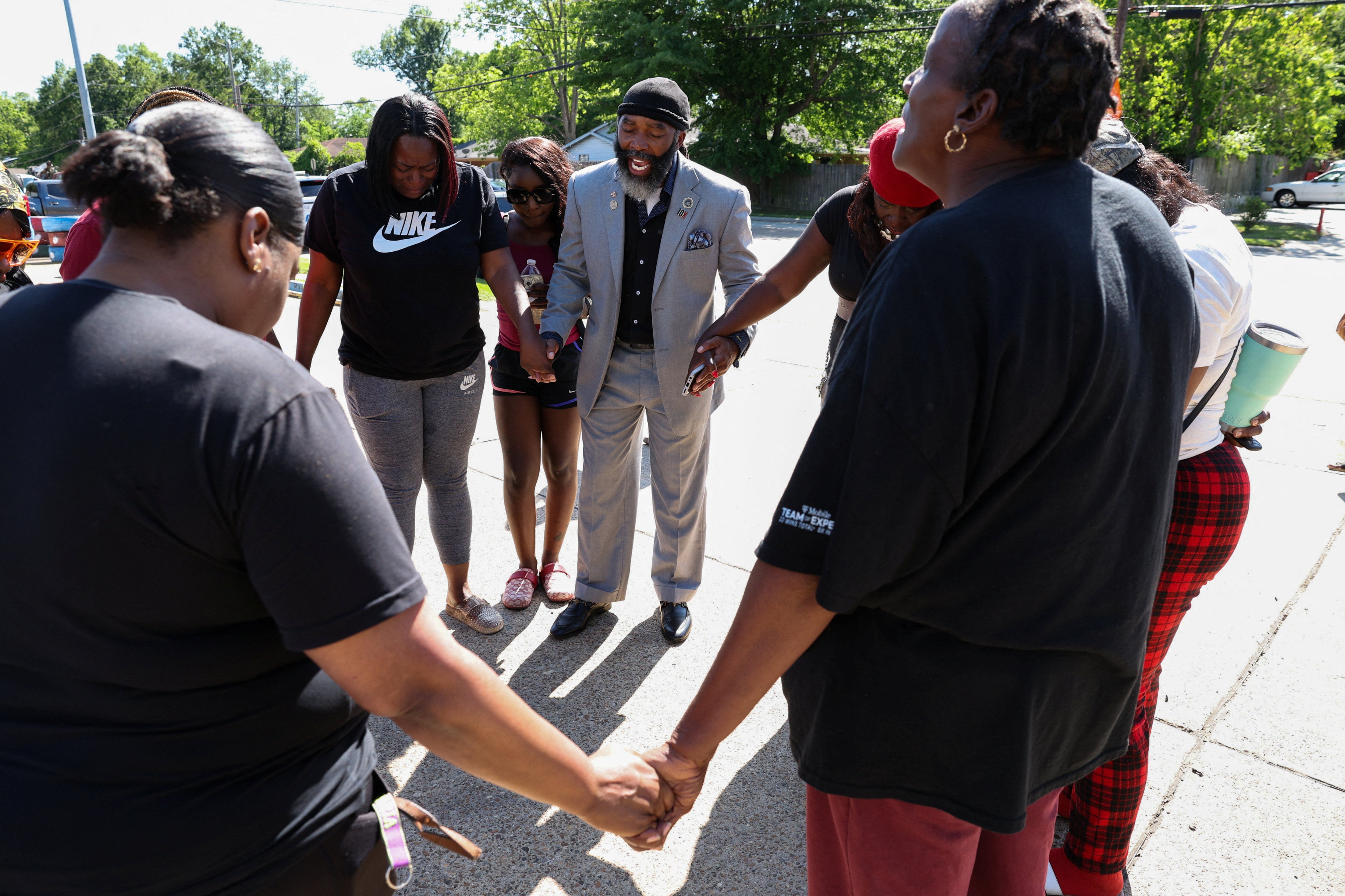 A local faith leader holds a prayer circle after 8 children, aged between 1 and 12, were killed in Louisiana Sunday