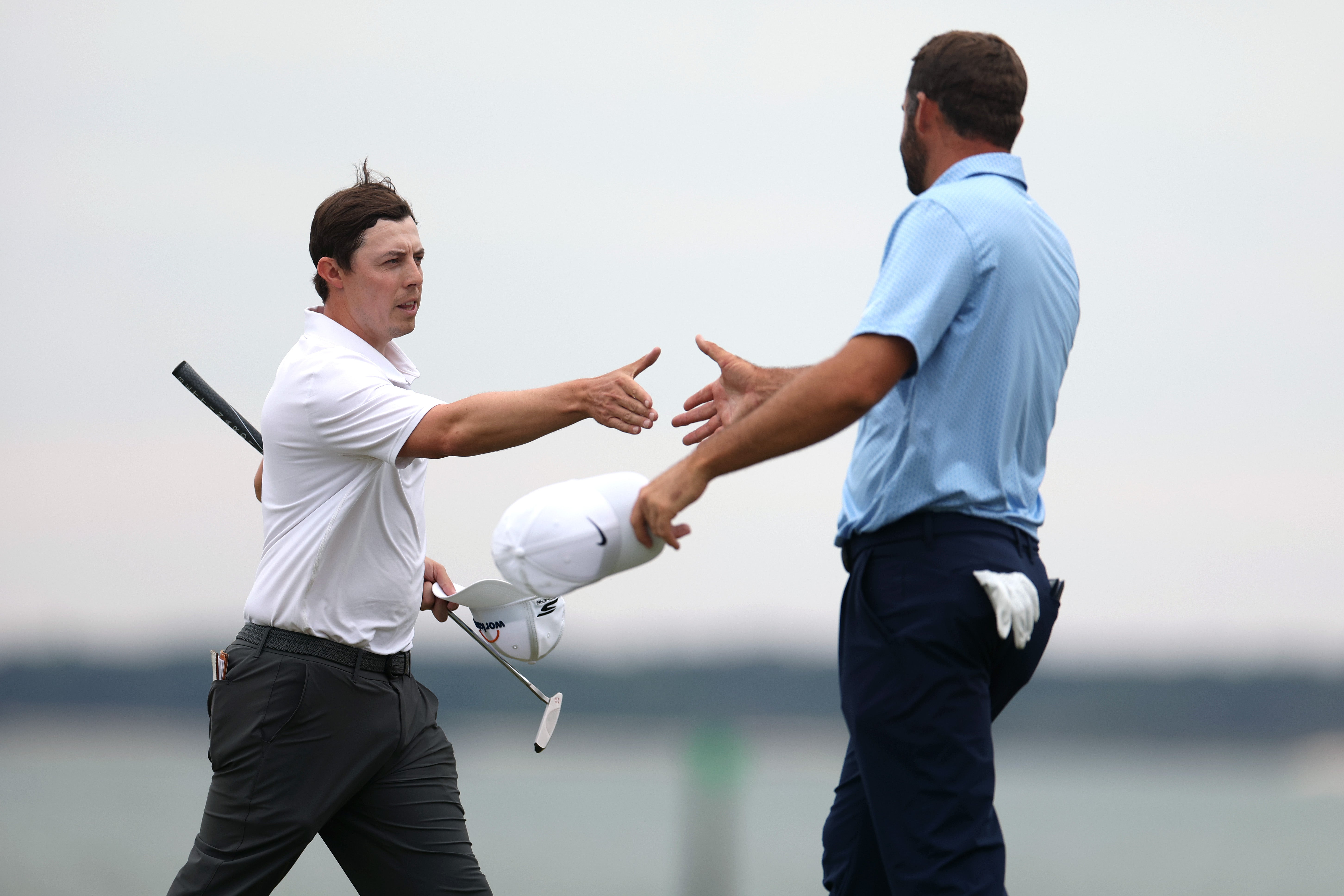Matt Fitzpatrick of England and Scottie Scheffler of the United States shake hands