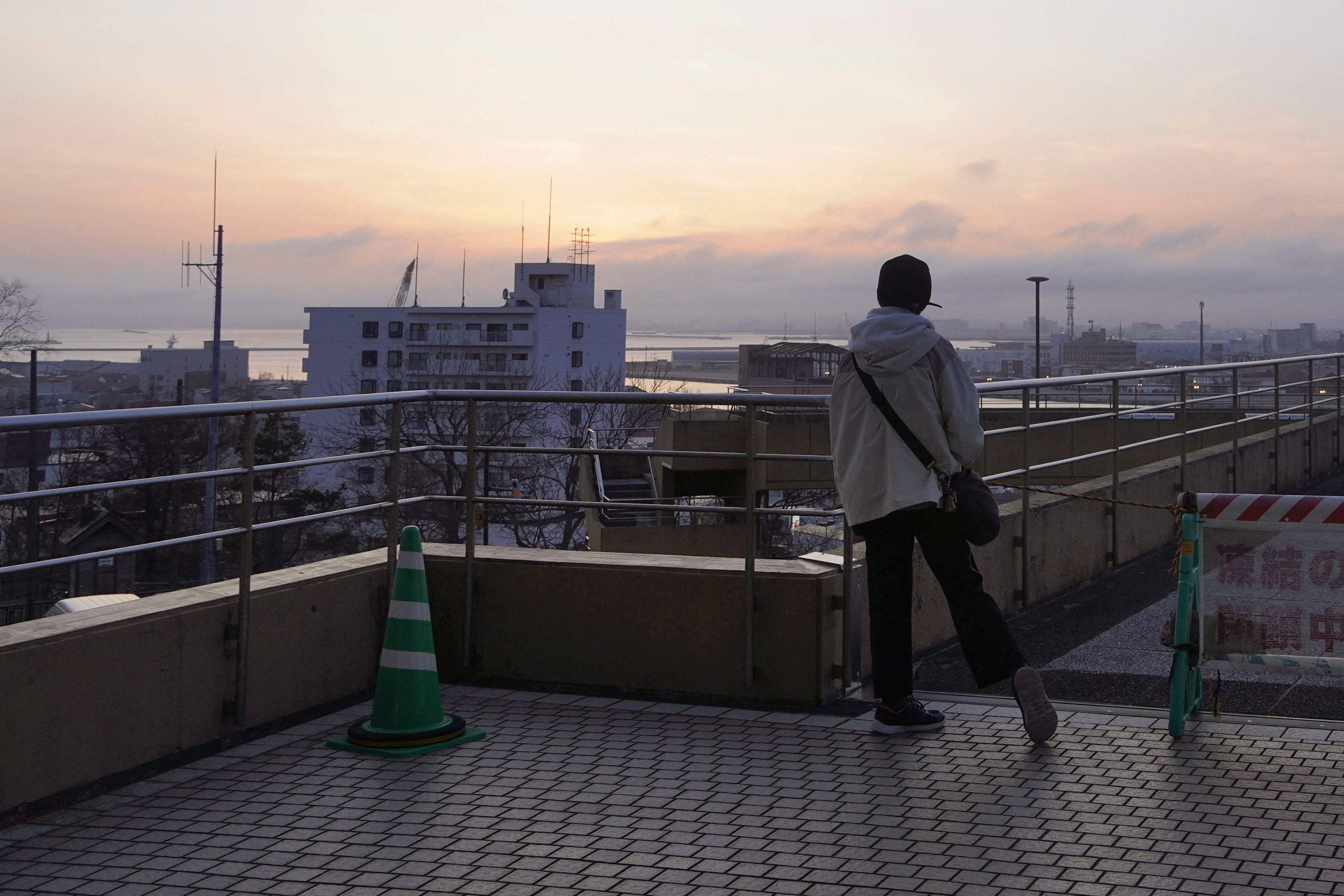 A local resident evacuates to a higher place after a tsunami warning was issued following an earthquake in Kushiro on Hokkaido, Japan's northernmost main island