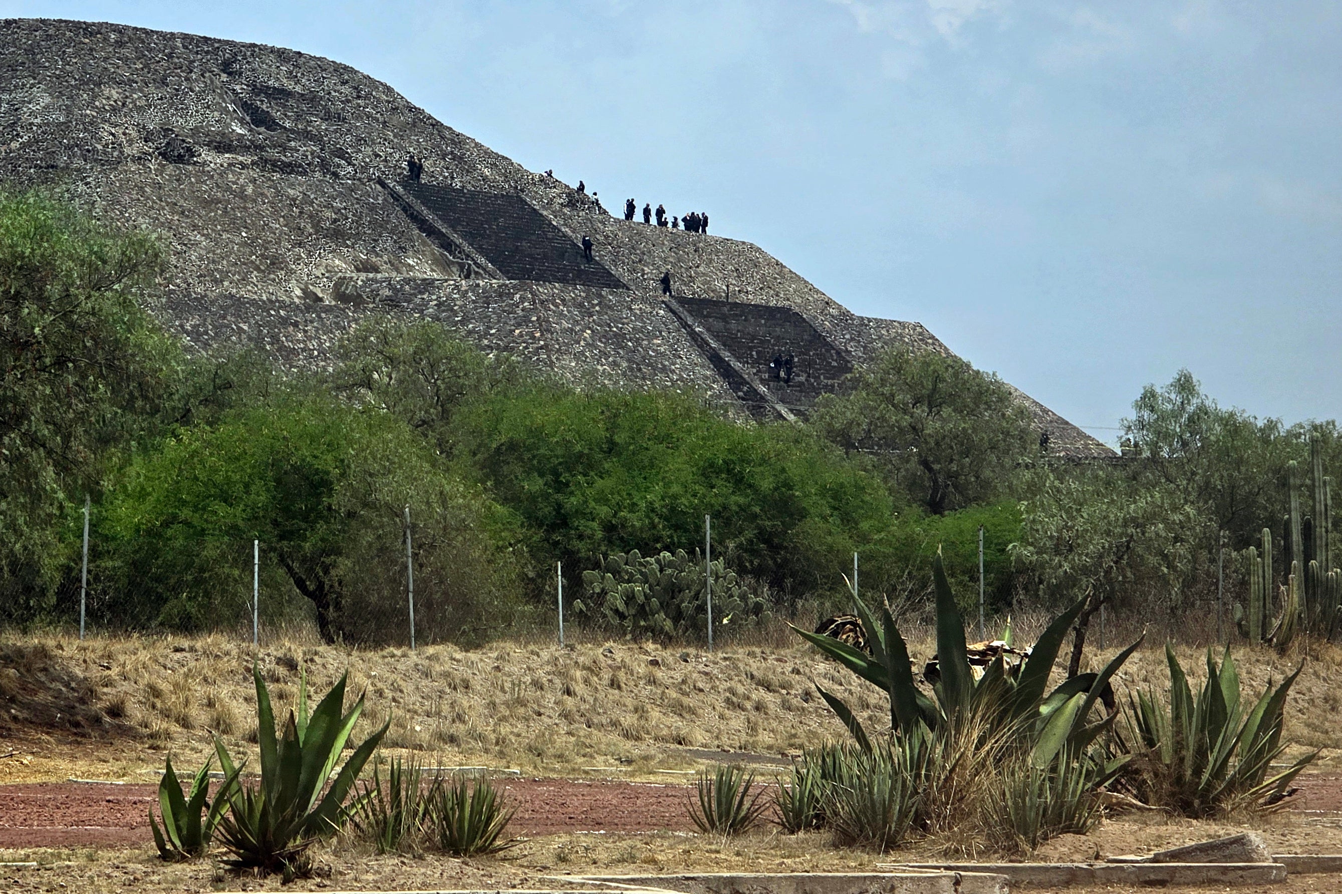 Police officers work on the Pyramid of the Moon at the Teotihuacan archaeological zone following a shooting