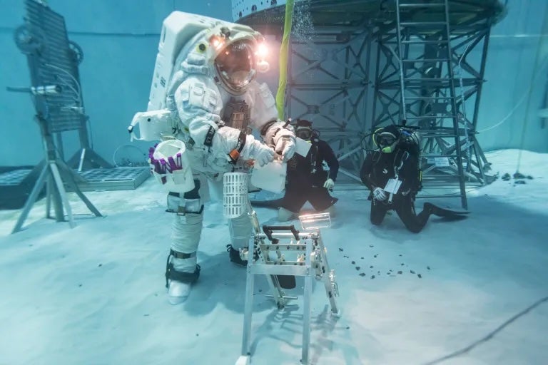 A NASA crew members uses the new Axiom Space suit underwater at NASA's Neutral Buoyancy Laboratory