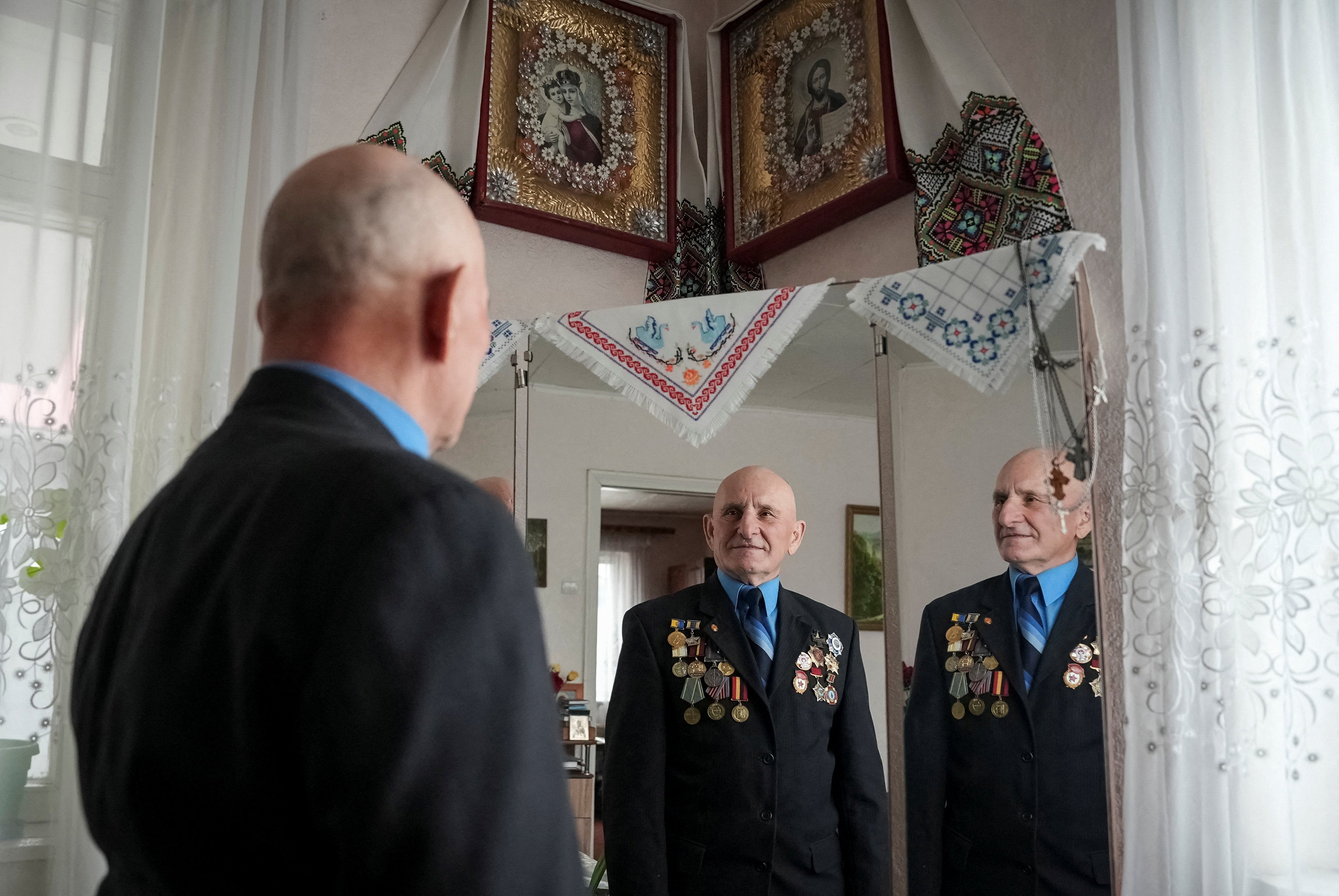Petro Hurin reflected in a mirror as he stands in his house in the village of Khutory