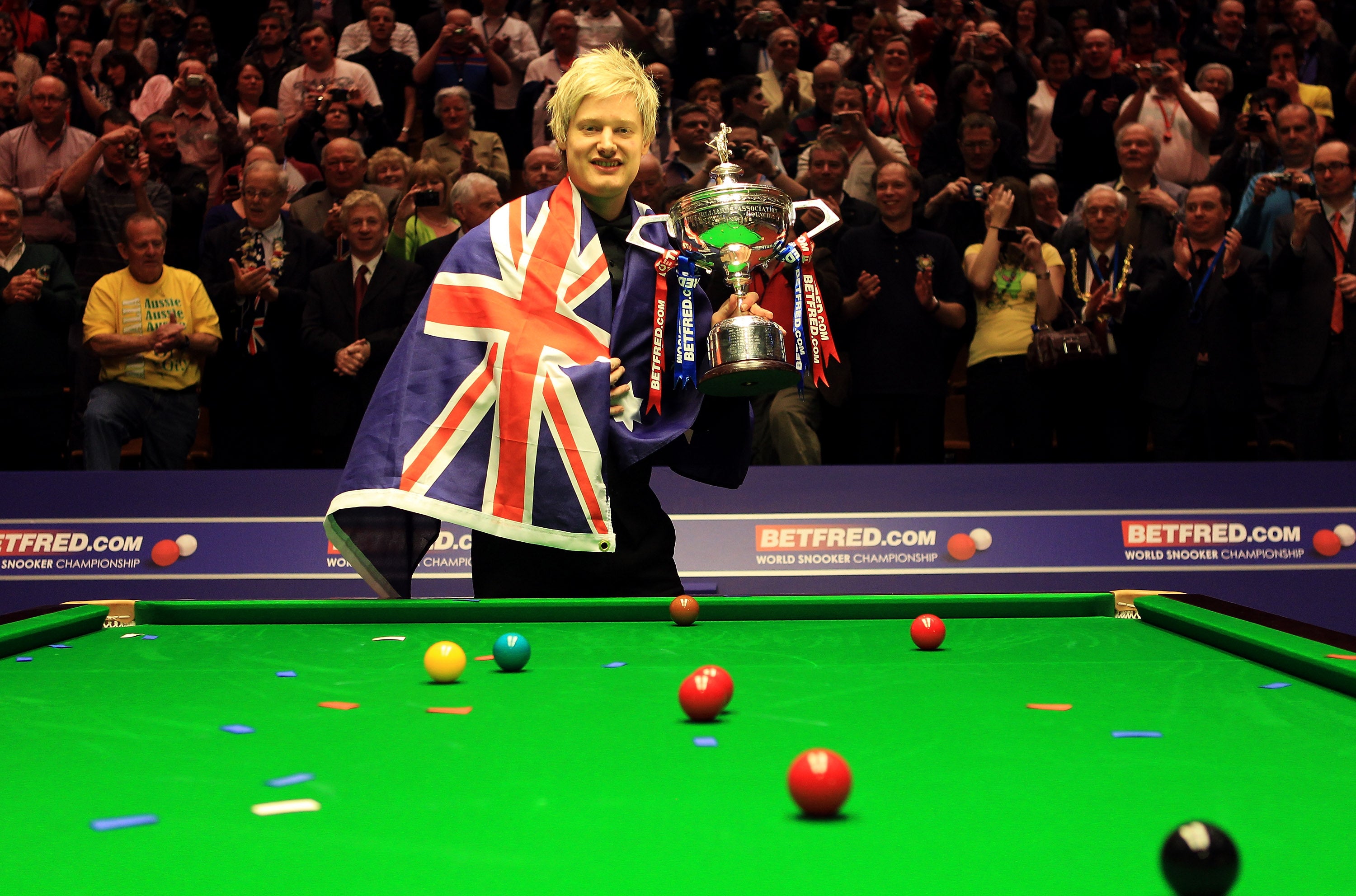 Neil Robertson poses with the World Championship trophy draped in an Australian flag