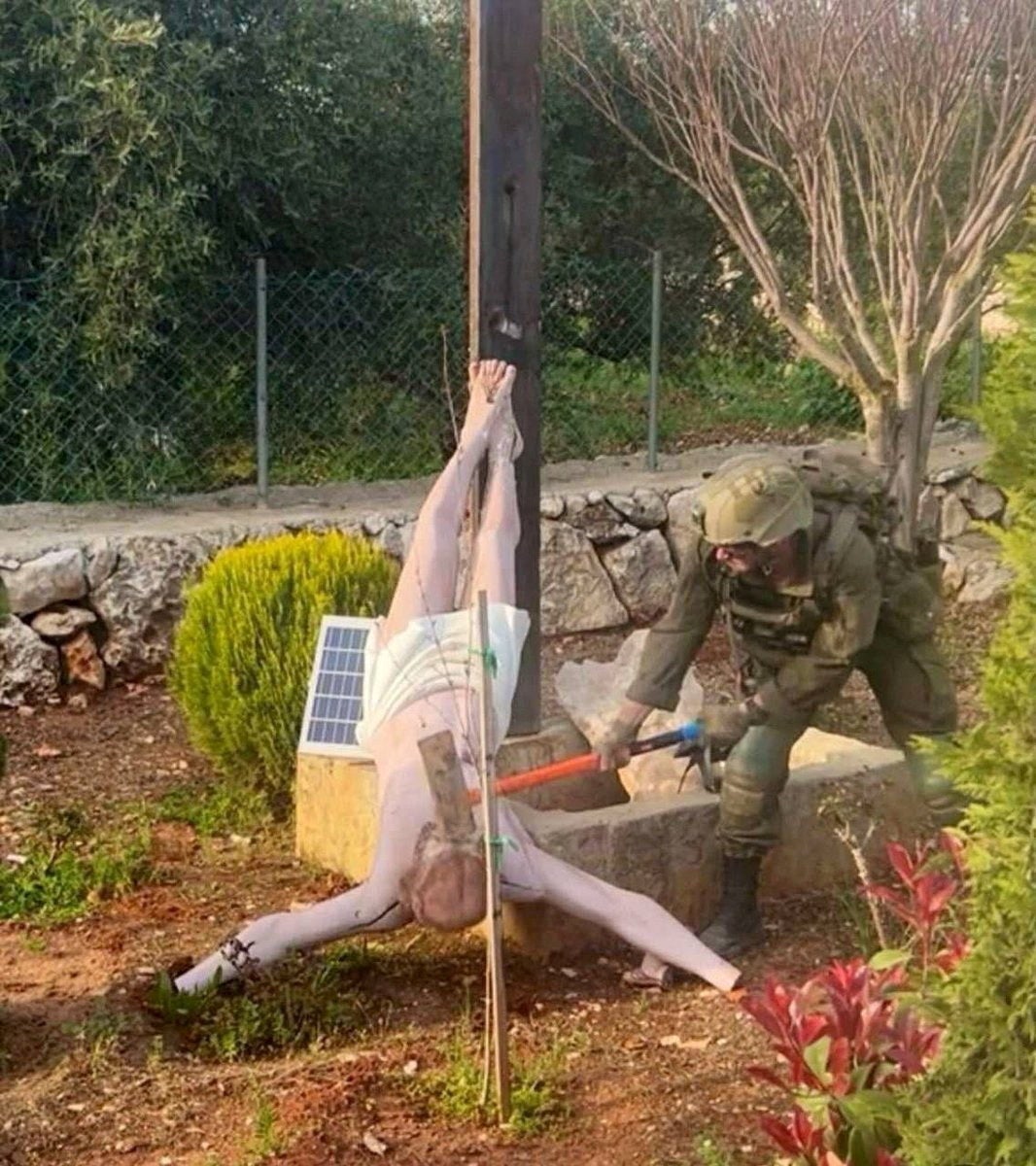 The Israeli soldier was photographed taking an axe to the head of a statue of Jesus, in Debel, Lebanon