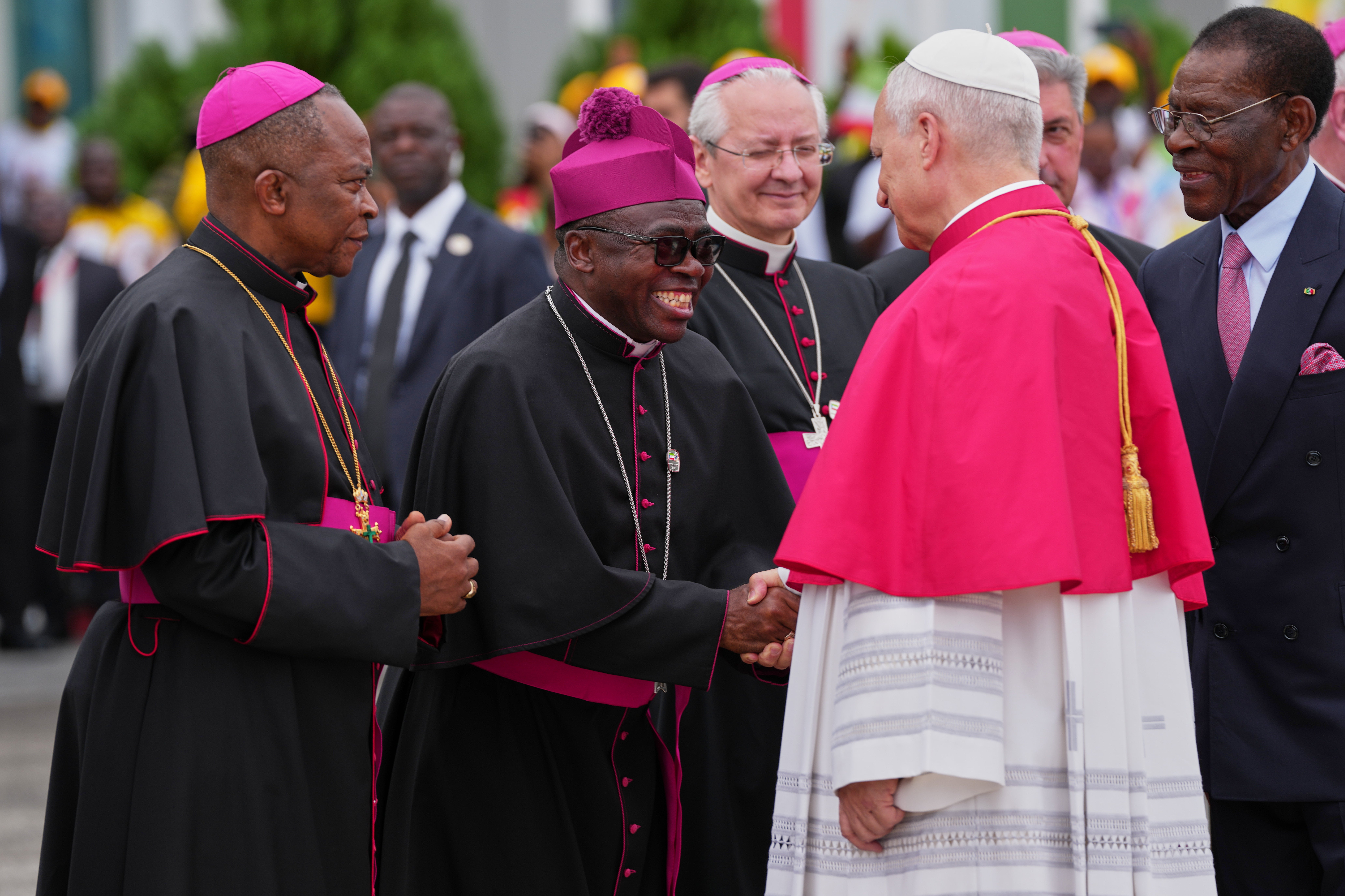 Pope Leo XIV, flanked by Equatorial Guinea's President Teodoro Obiang Nguema Mbasogo, right, is welcomed by Archbishop Juan Nsue Edjang Mayé, left, and Juan Domingo-Beka Esono Ayang upon his arrival at Malabo International Airport in Malabo, Equatorial Guinea