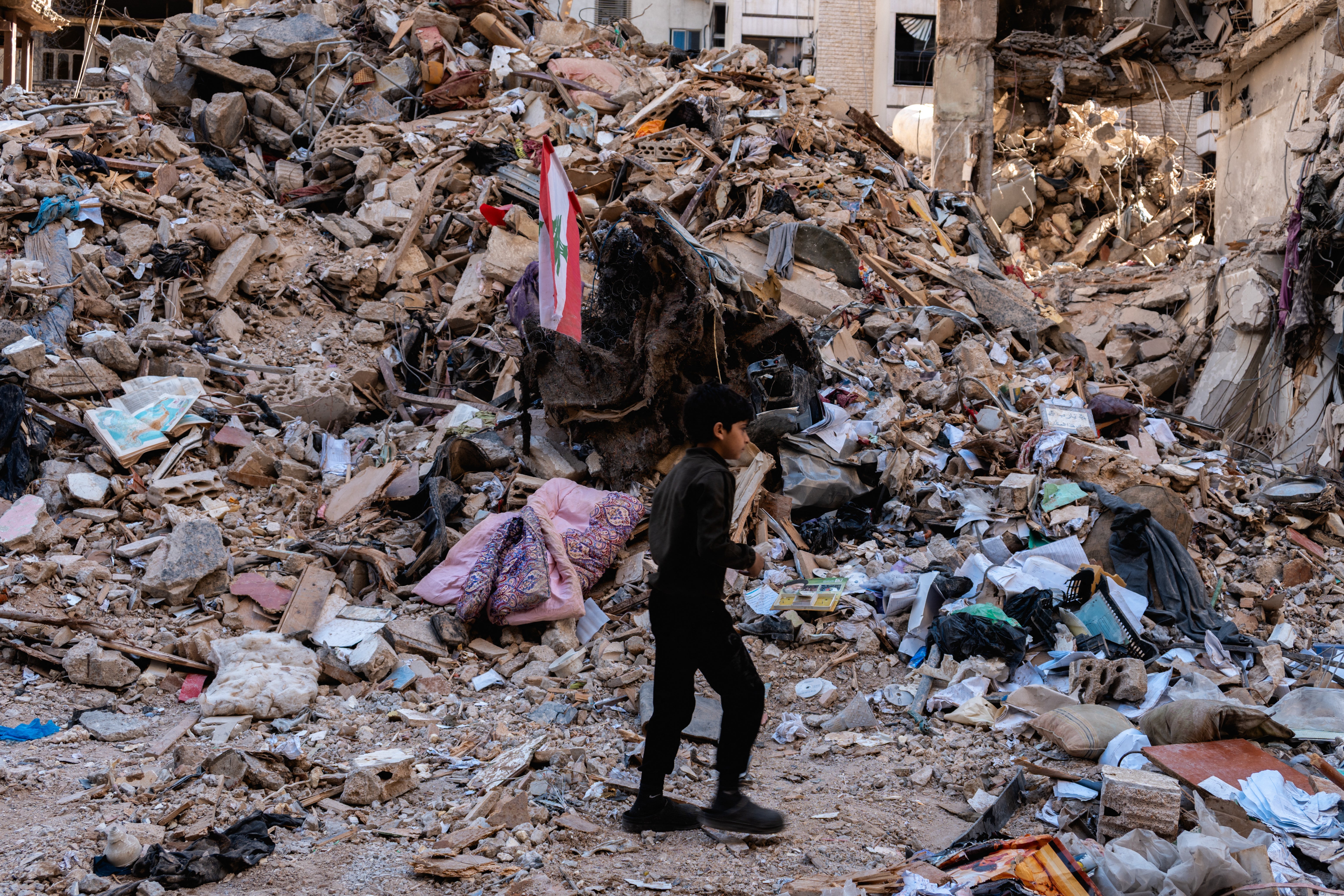 A boy stands near a destroyed building in the residential neighbourhood of Ain El Mreisseh near the seafront in Beirut, Lebanon, on 11 April
