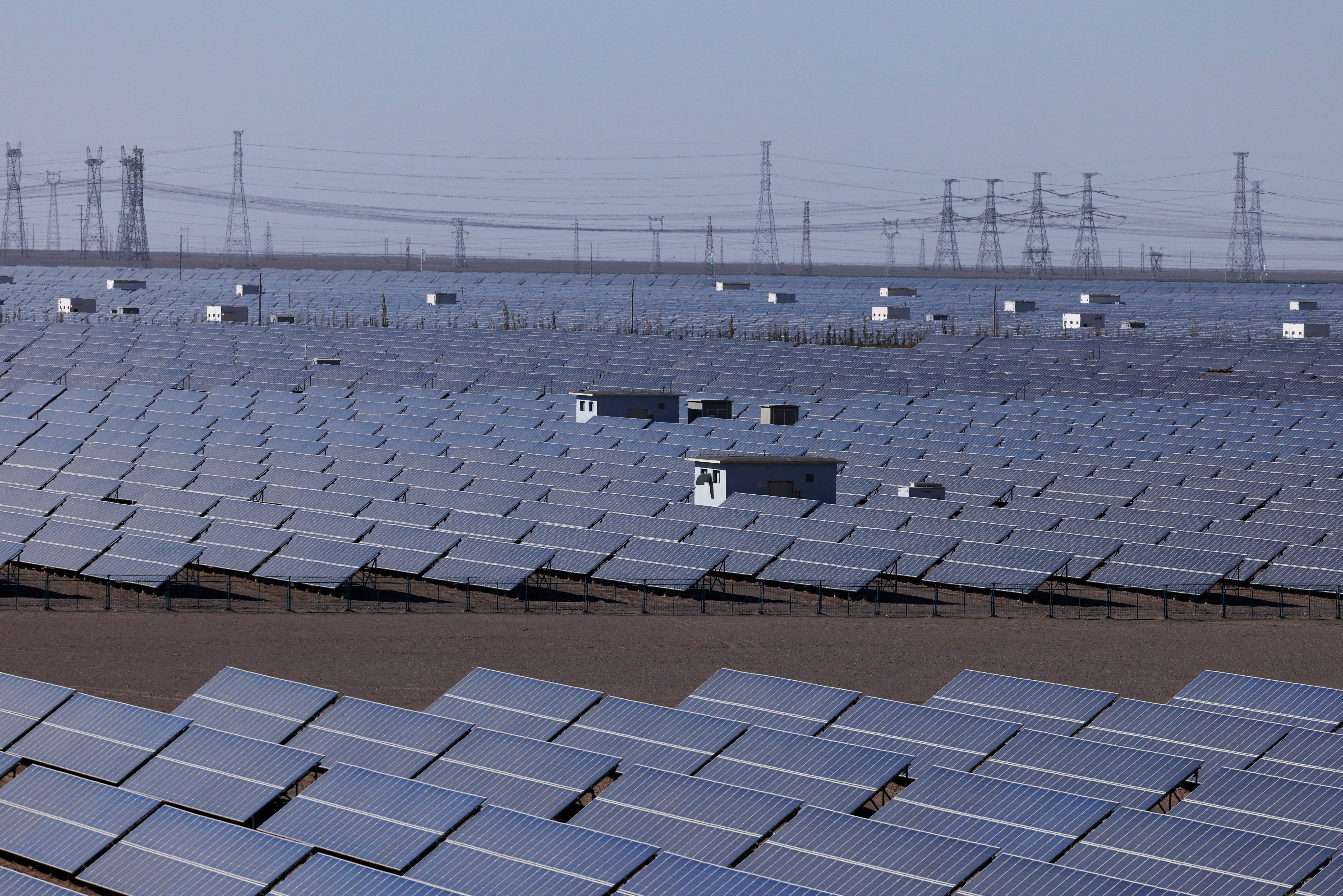 File. Solar panels at Dunhuang Photovoltaic Industrial Park in China’s Gansu province