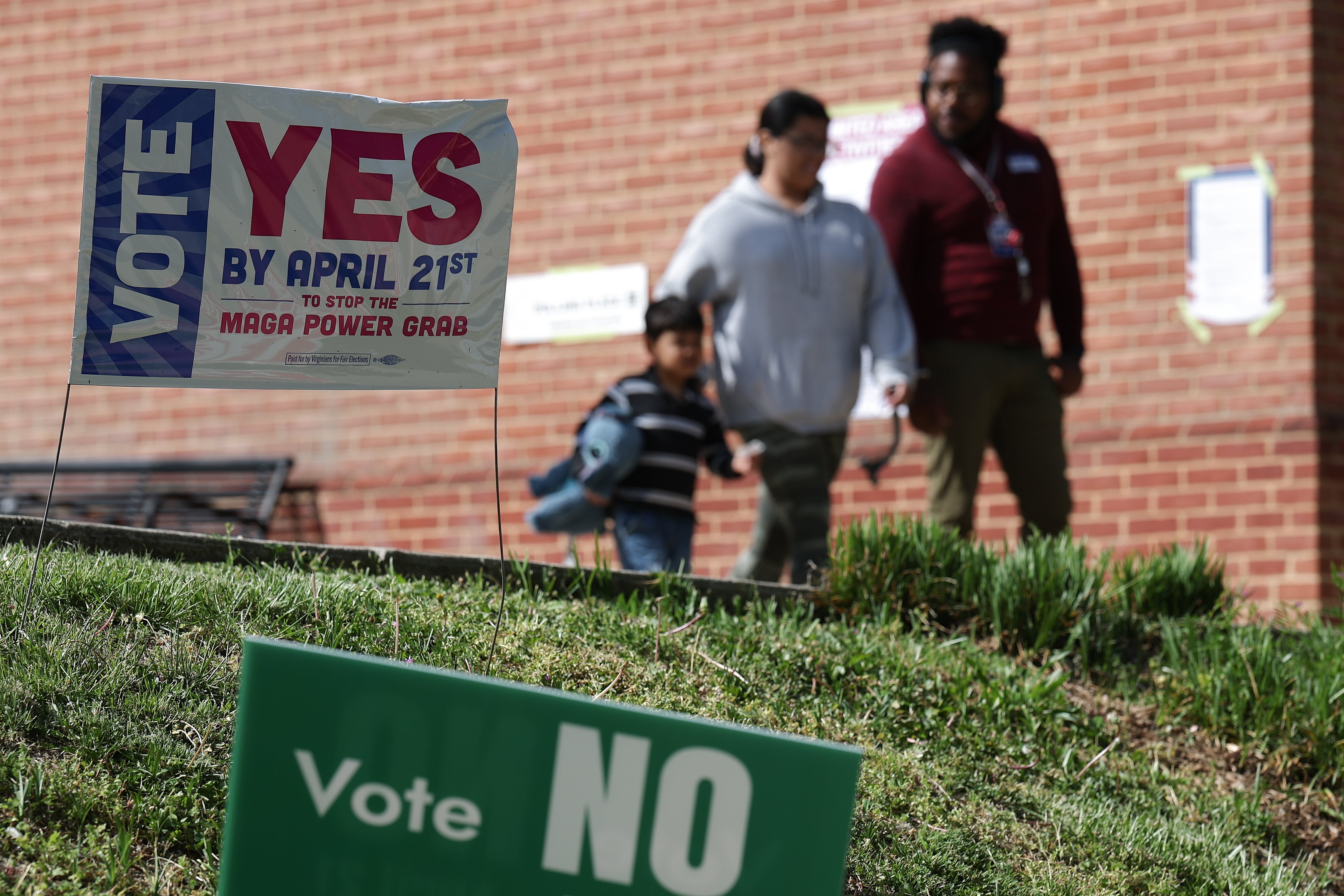 Voters depart after casting their ballots at a polling location at the Westover Library on April 21
