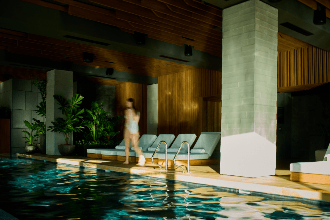 The swimming pool is flooded by light