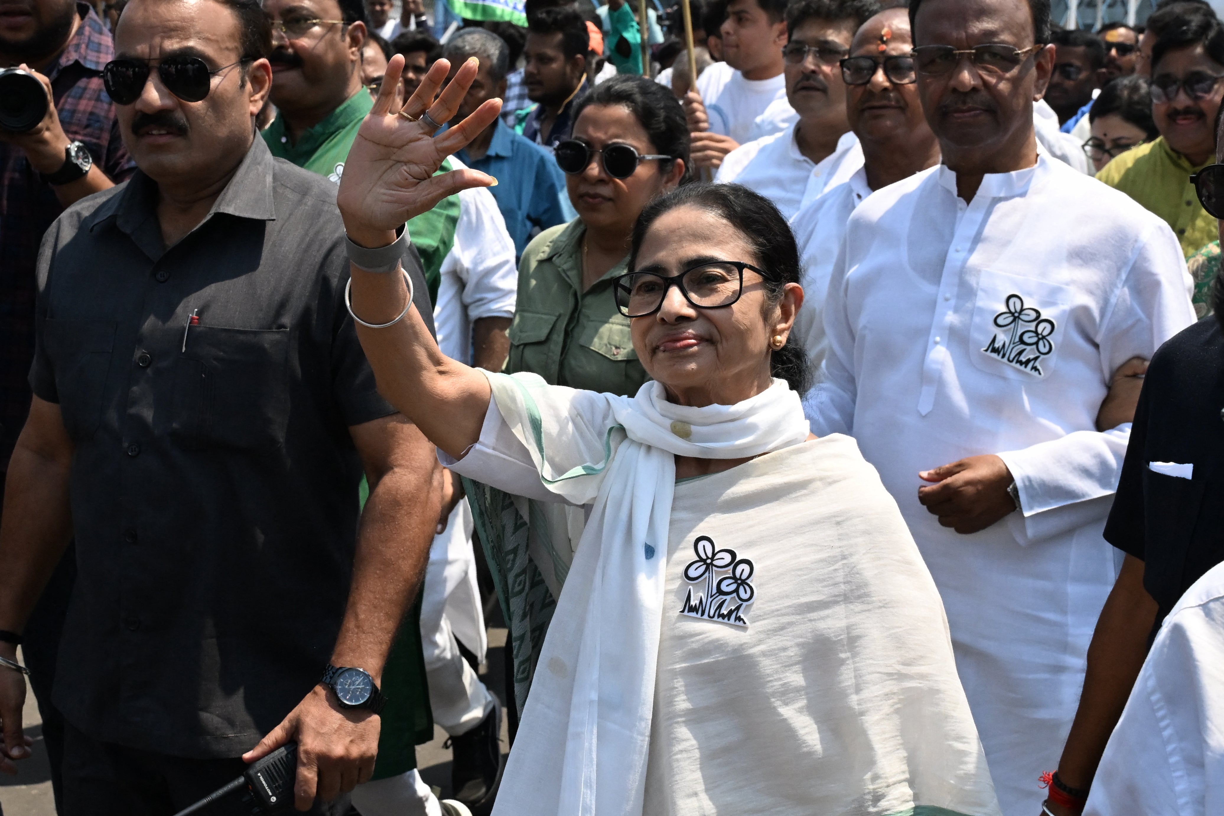West Bengal chief minister Mamata Banerjee greets supporters as she arrives to file her nomination papers earlier this month