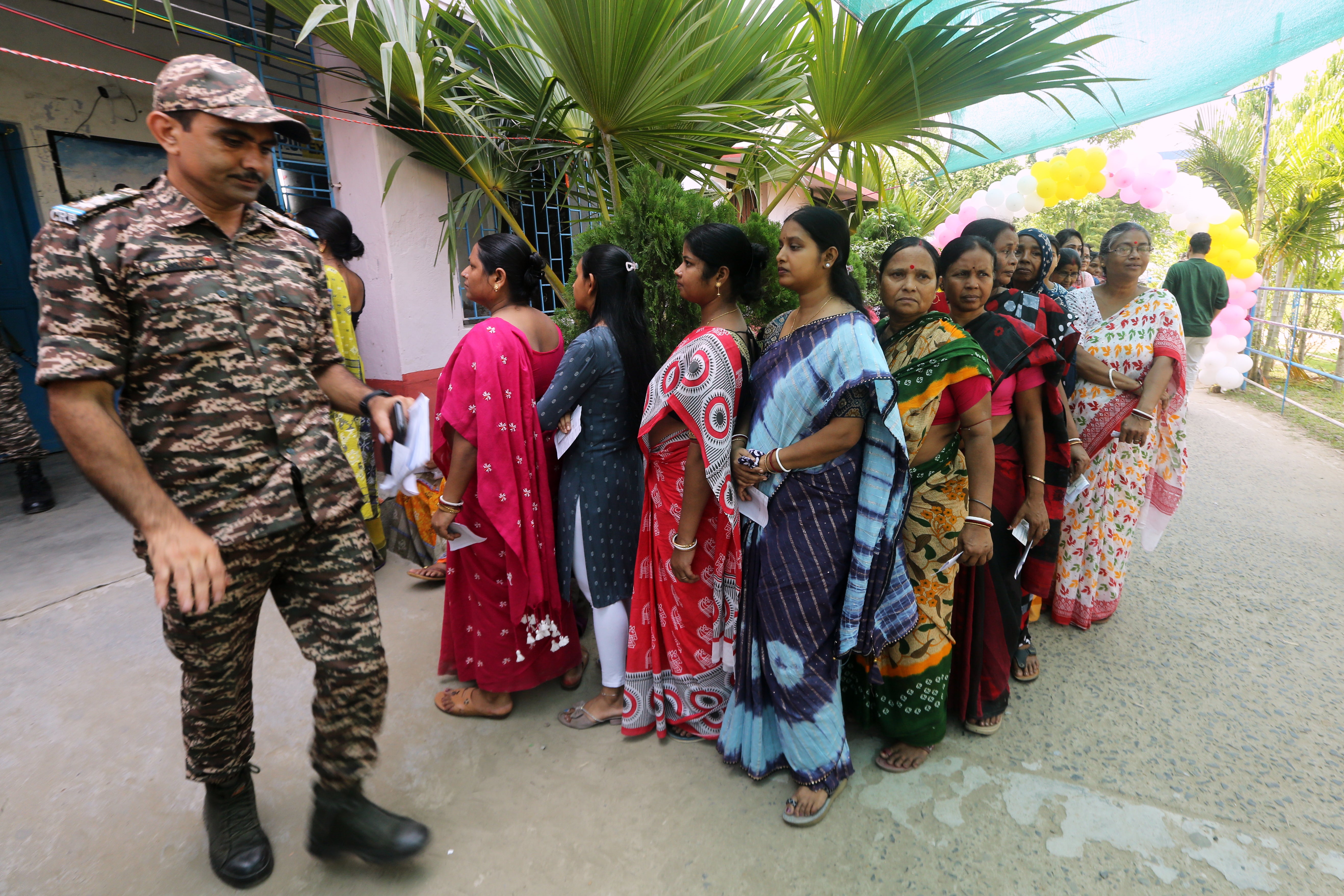 Voters queue at a polling booth for the first phase of voting in West Bengal state elections in Nandigram, a town to the south of Kolkata